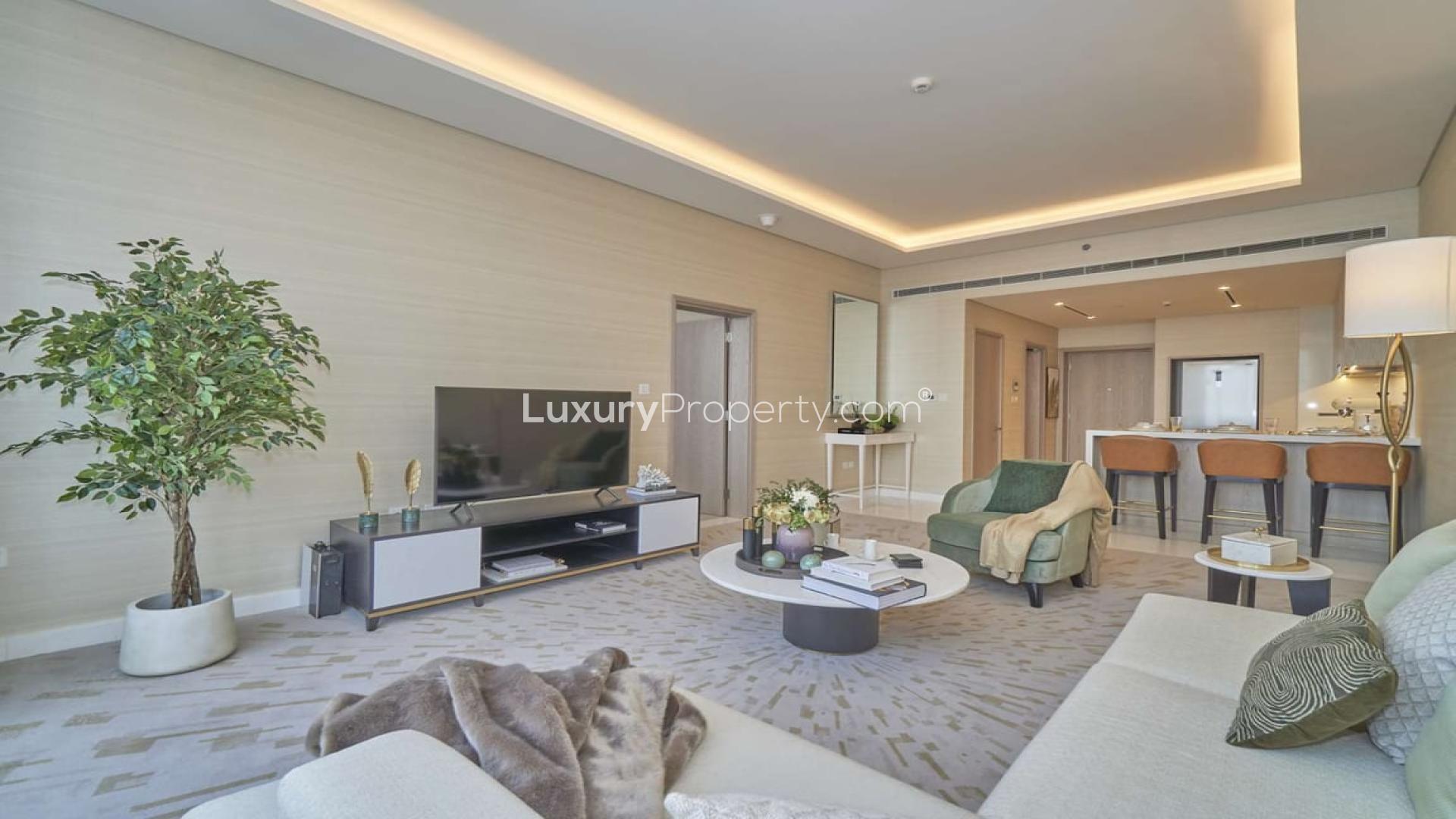Modern living room in Palm Jumeirah apartment, featuring elegant decor and open kitchen layout