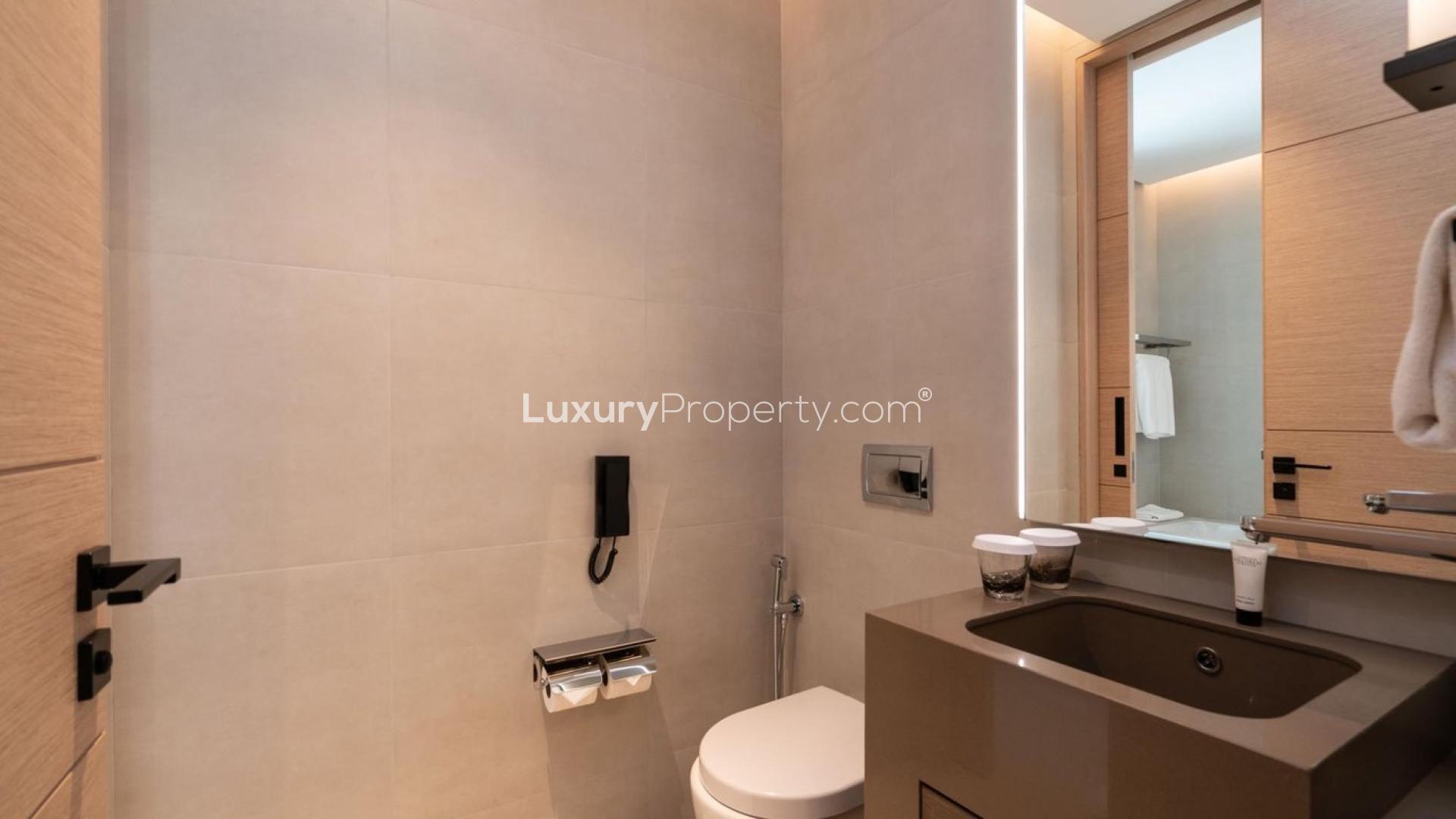 Modern living room in Jumeirah Beach Residence apartment with balcony view, stylish decor, and TV