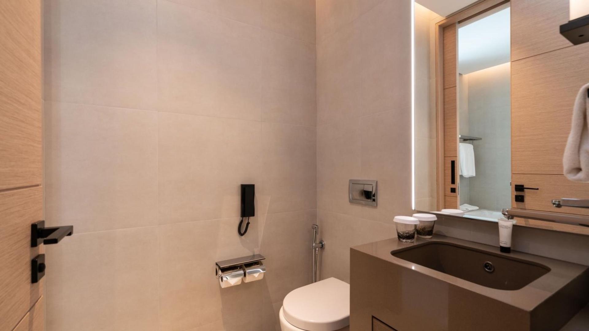 Modern living room in Jumeirah Beach Residence apartment with balcony view, stylish decor, and TV