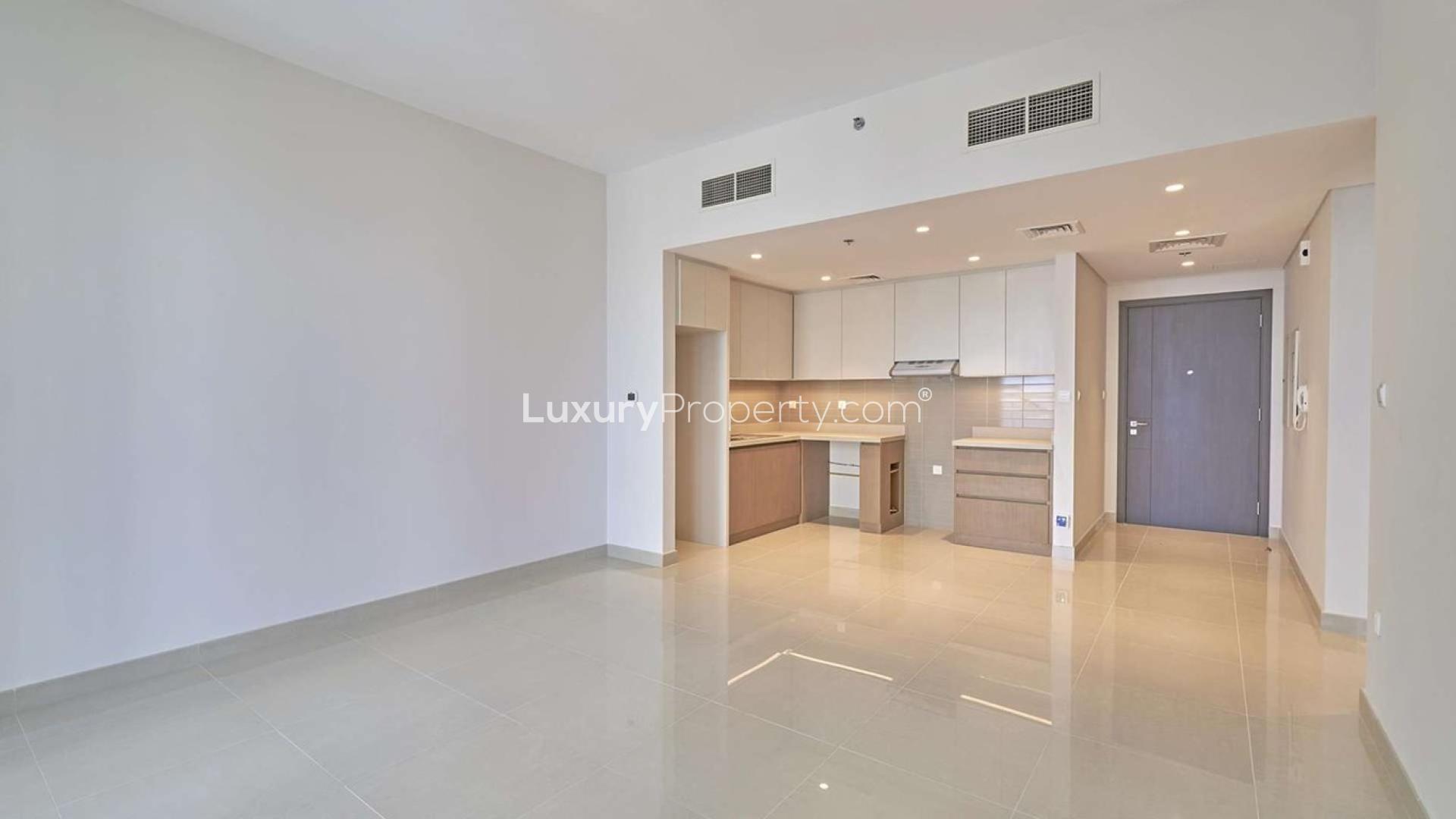 Empty modern kitchen and living area in Dubai Creek Harbour apartment for sale