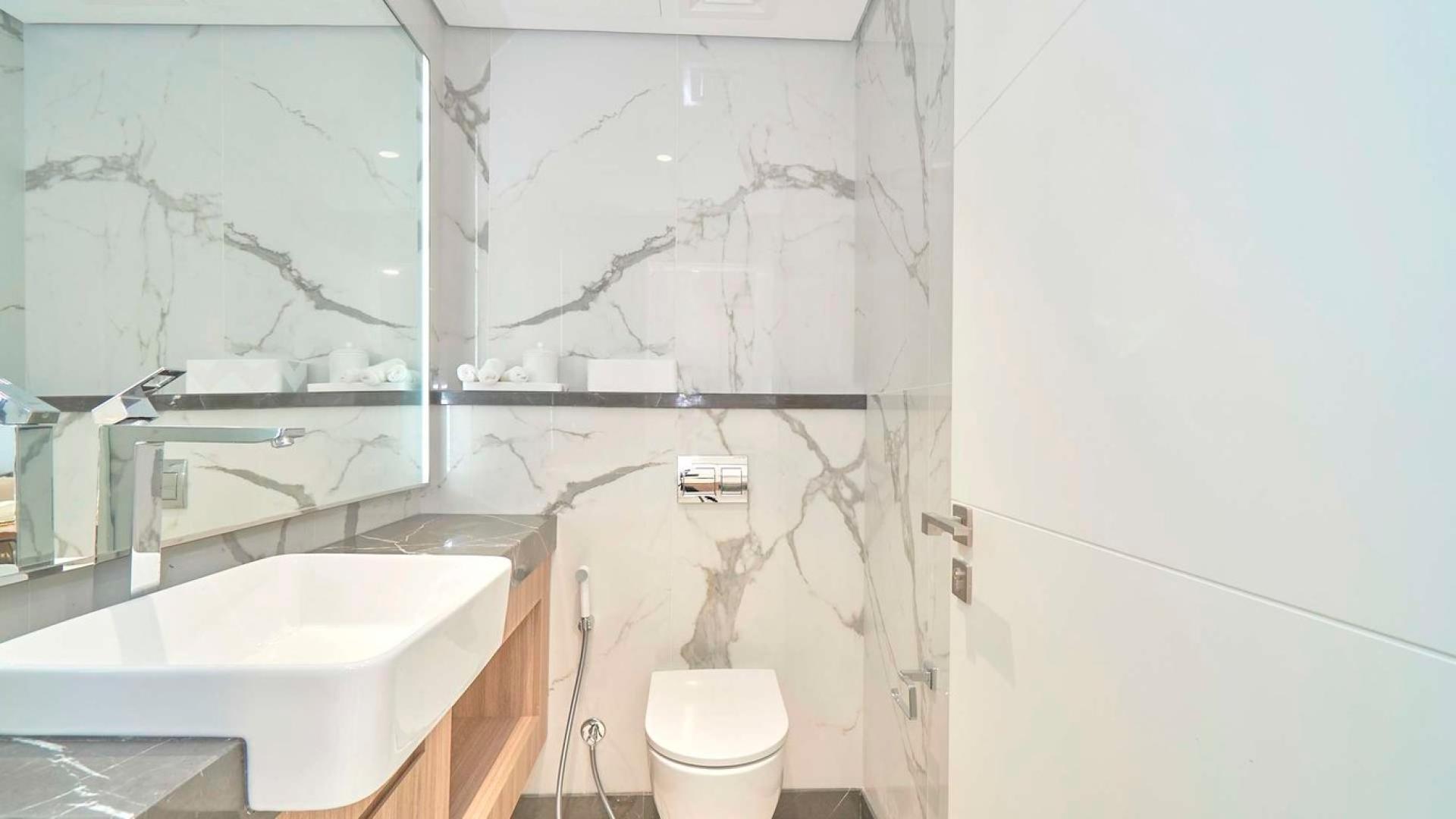 "The Pinnacle Tower apartment exterior in Dubai Hills Estate, modern architecture for sale.",Modern bathroom in Pinnacle Tower studio apartment, Dubai Hills Estate, sleek design, marble finish