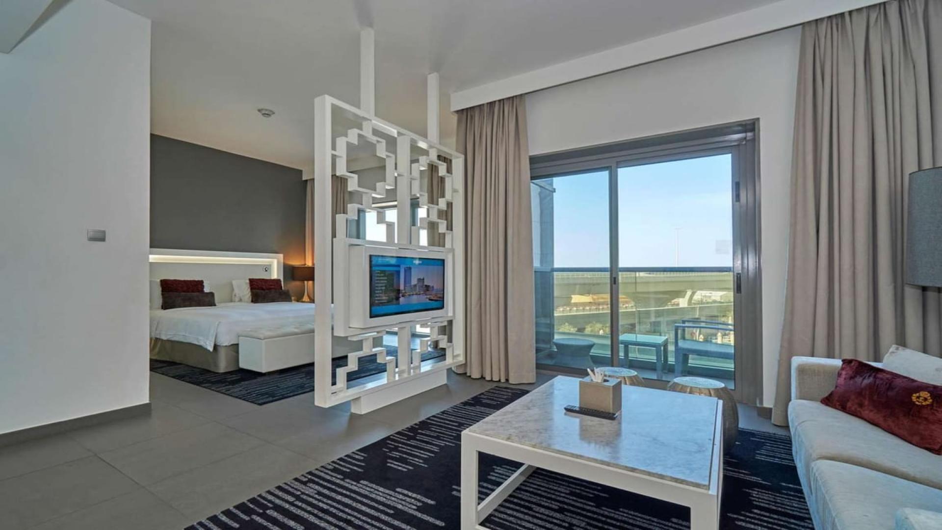 Modern living room in serviced Dubai Marina apartment with stylish decor and flat-screen TV