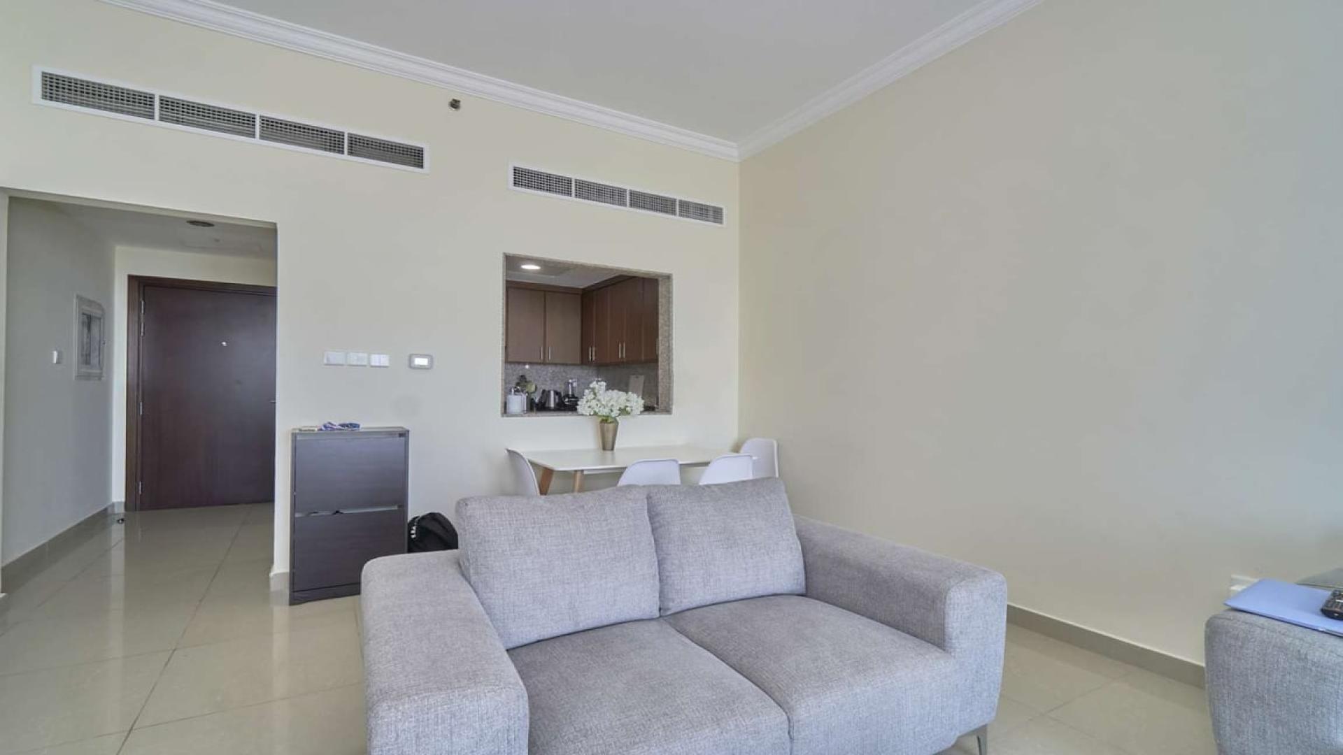 Modern kitchen in Fairview Residency apartment, Business Bay, featuring granite countertops and appliances