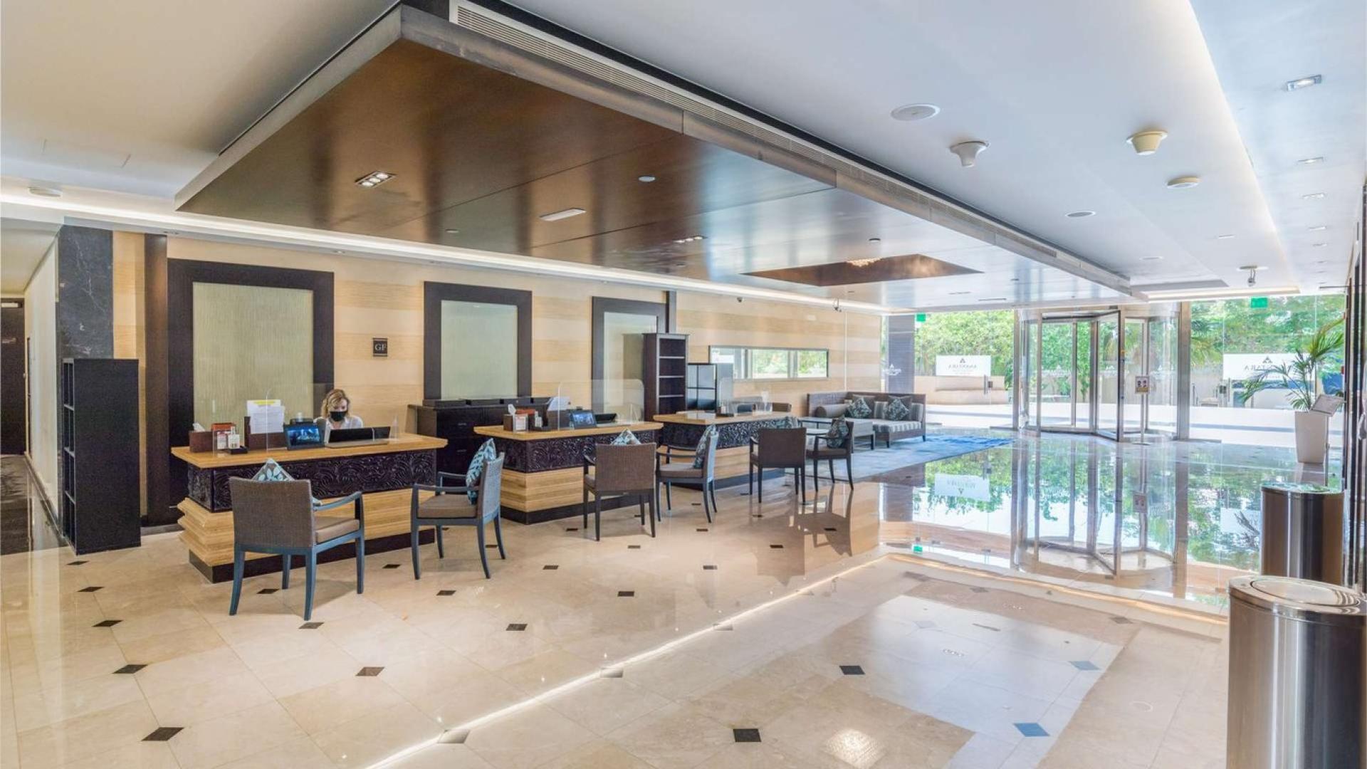 Furnished living room in Anantara Residences apartment, Palm Jumeirah, with modern decor and dining area
