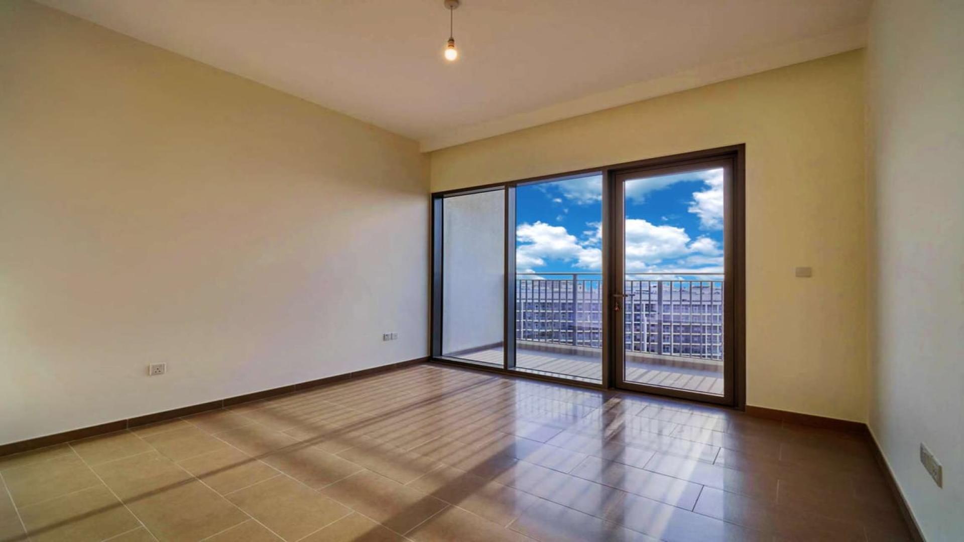 Apartment buildings in Park Heights, Dubai Hills Estate, with street view and clear sky