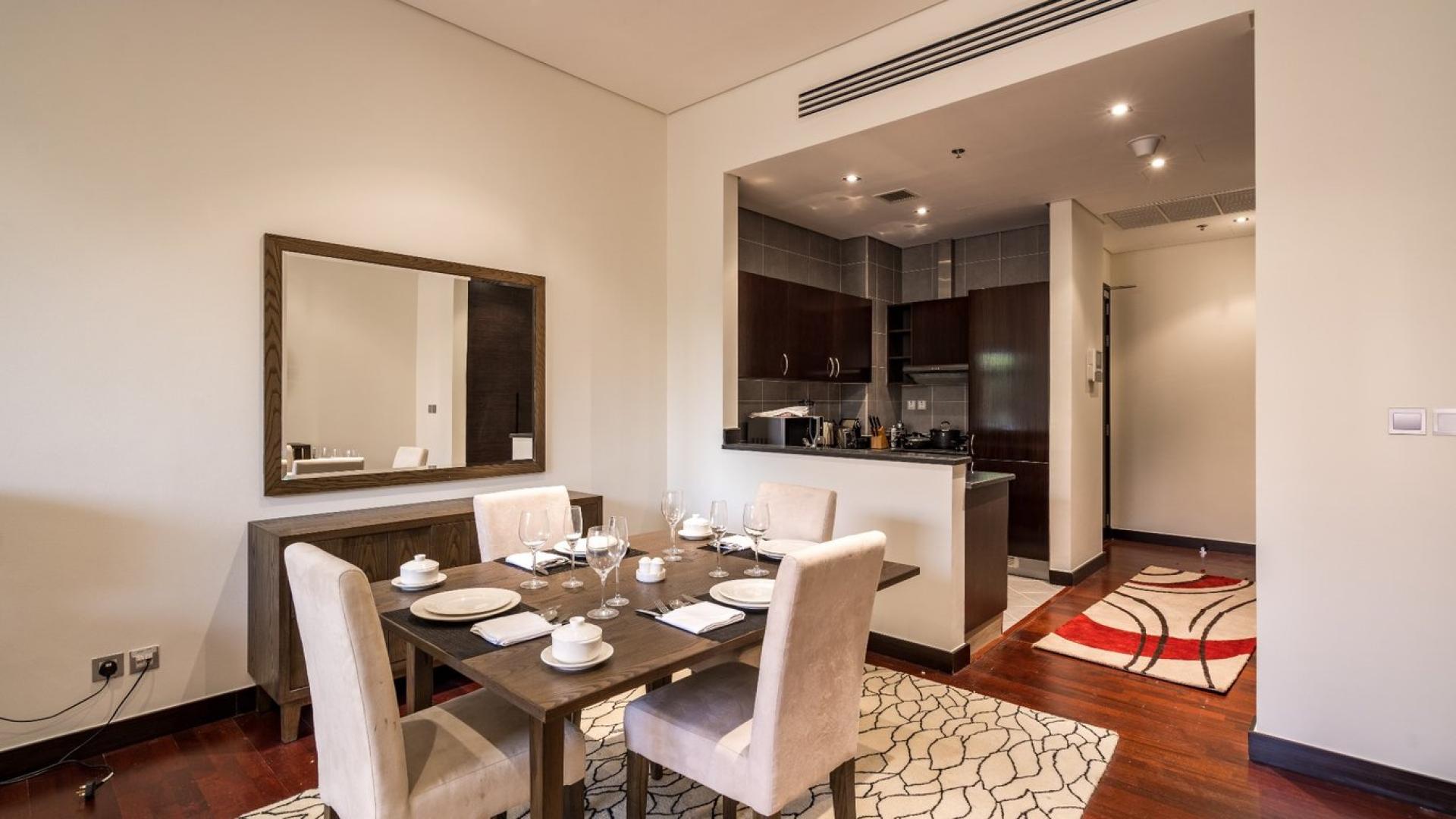"Spacious bedroom in Anantara North Residence apartment, Palm Jumeirah, with modern decor and balcony view.",Dining area and kitchen in Anantara North Residence apartment, Palm Jumeirah for sale