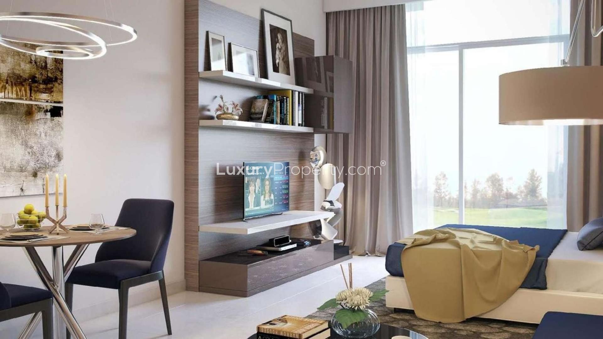 High-rise apartment buildings overlooking golf course in Damac Hills, The Drive community