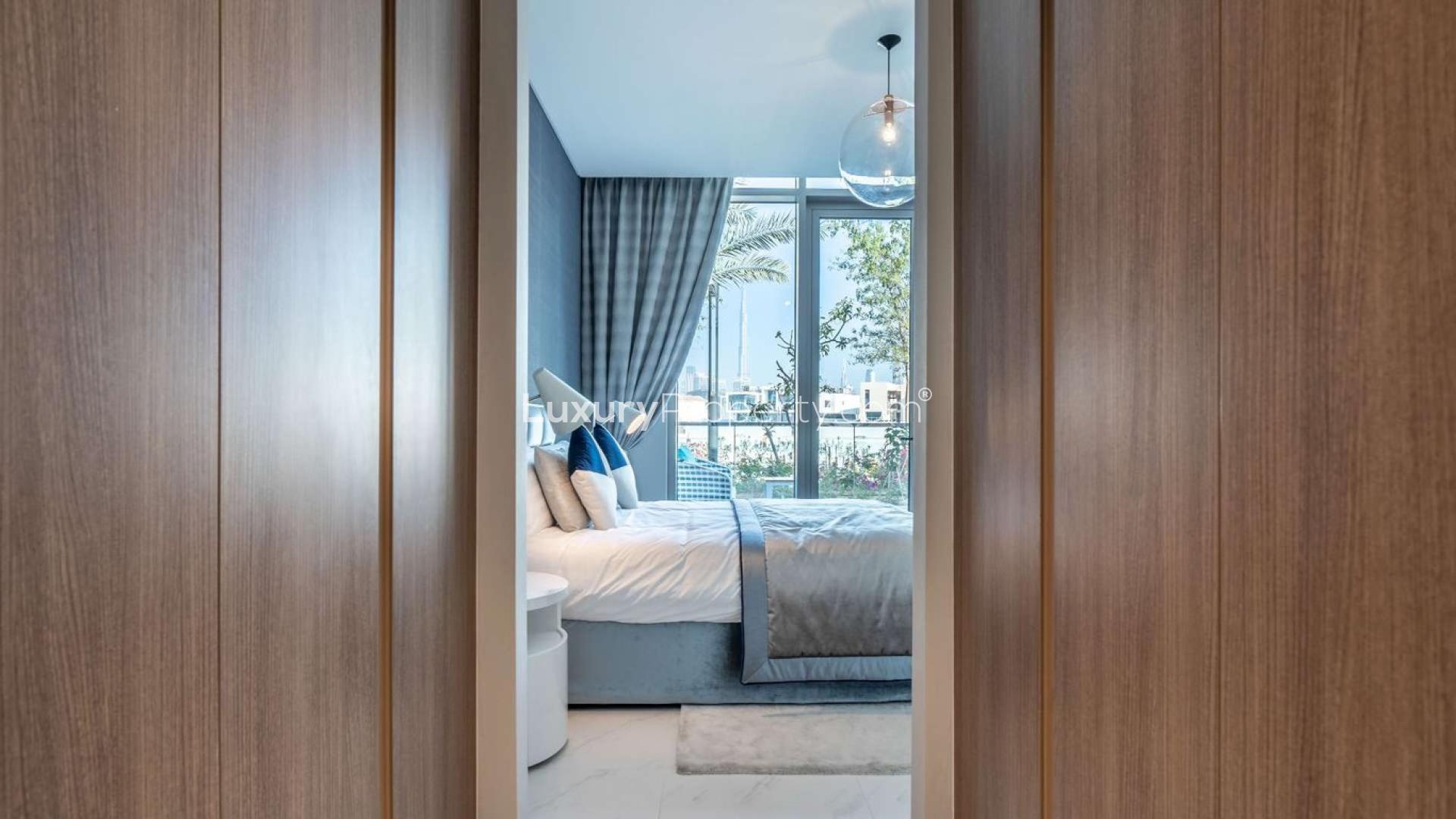 "Bright living room in District One apartment with modern decor and large windows.",1-bedroom apartment in District One with modern decor and lagoon view through large windows