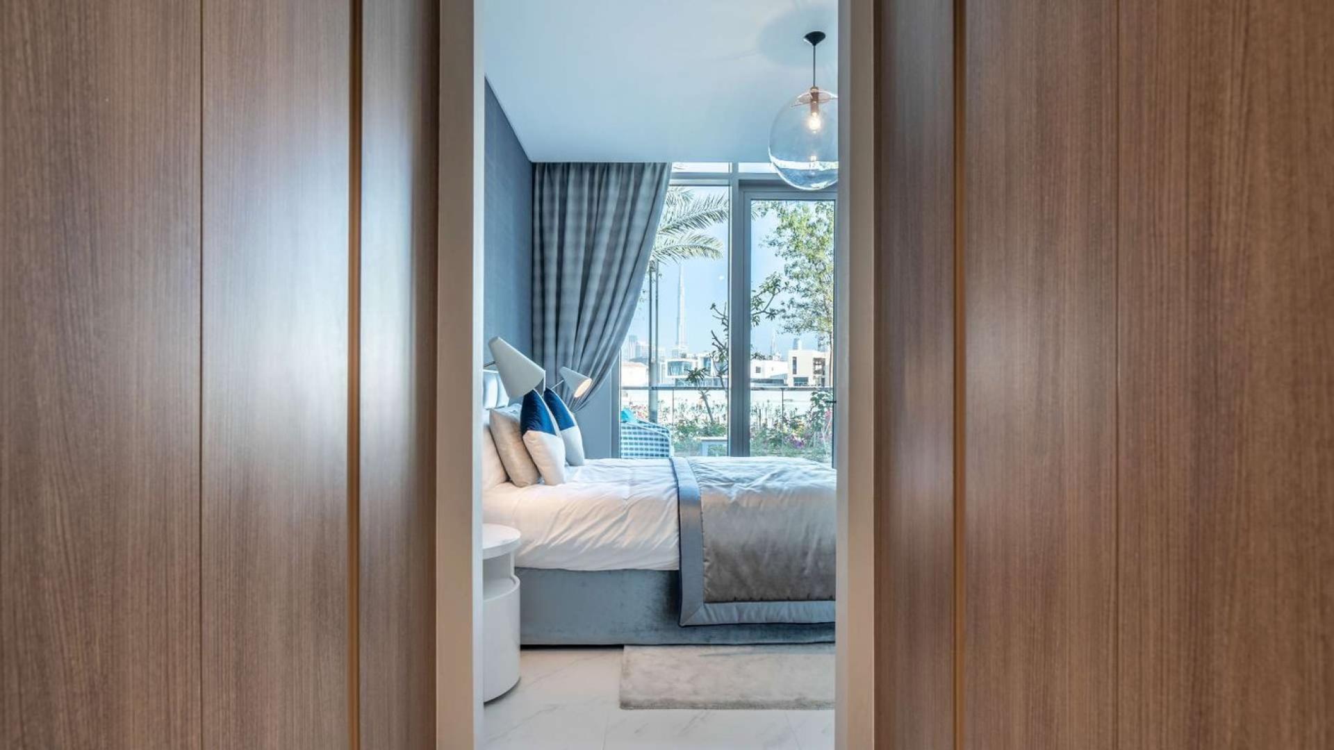 "Bright living room in District One apartment with modern decor and large windows.",1-bedroom apartment in District One with modern decor and lagoon view through large windows
