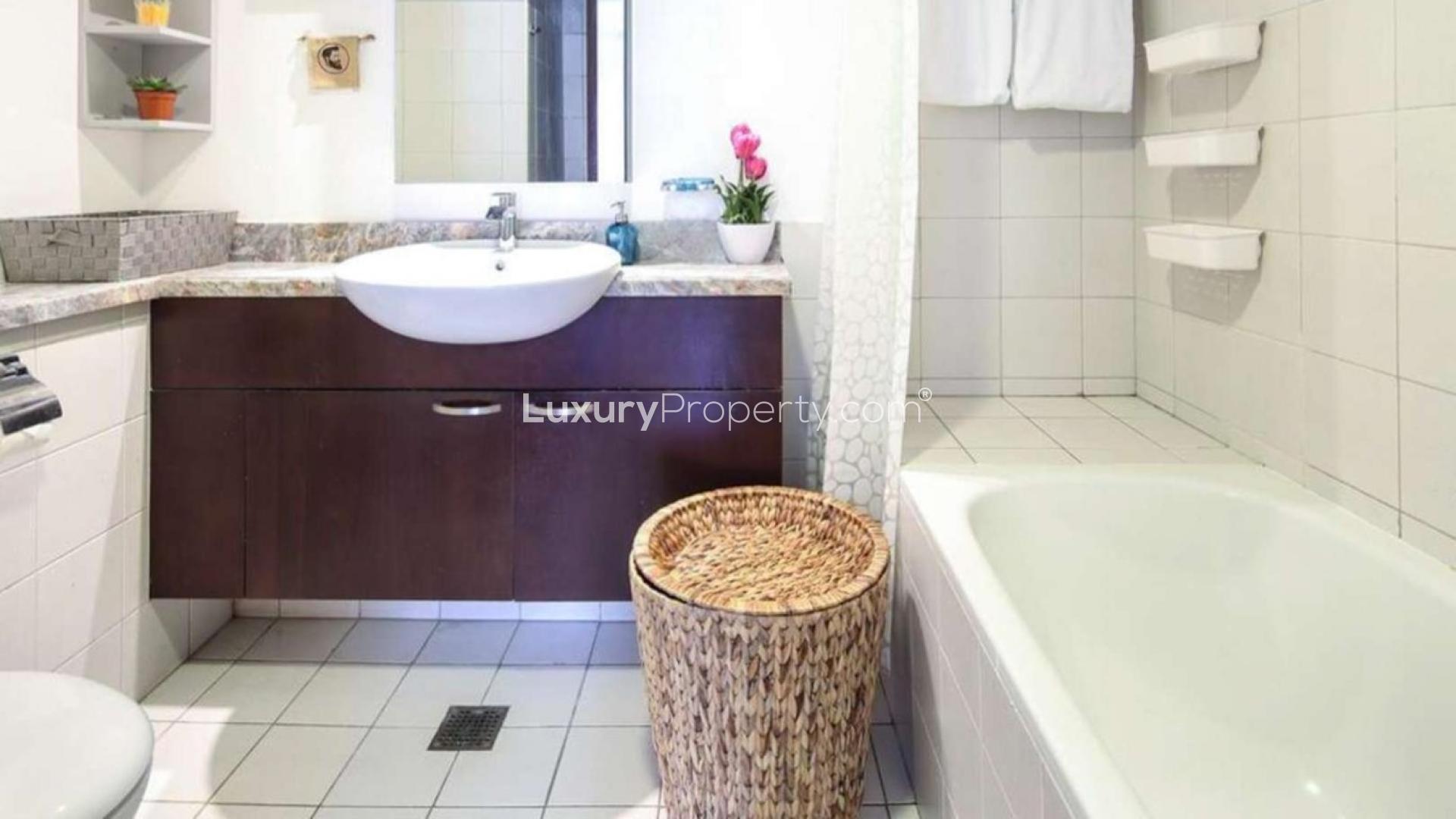 Stylish living room in Dubai Marina apartment for sale, featuring modern decor and cozy seating