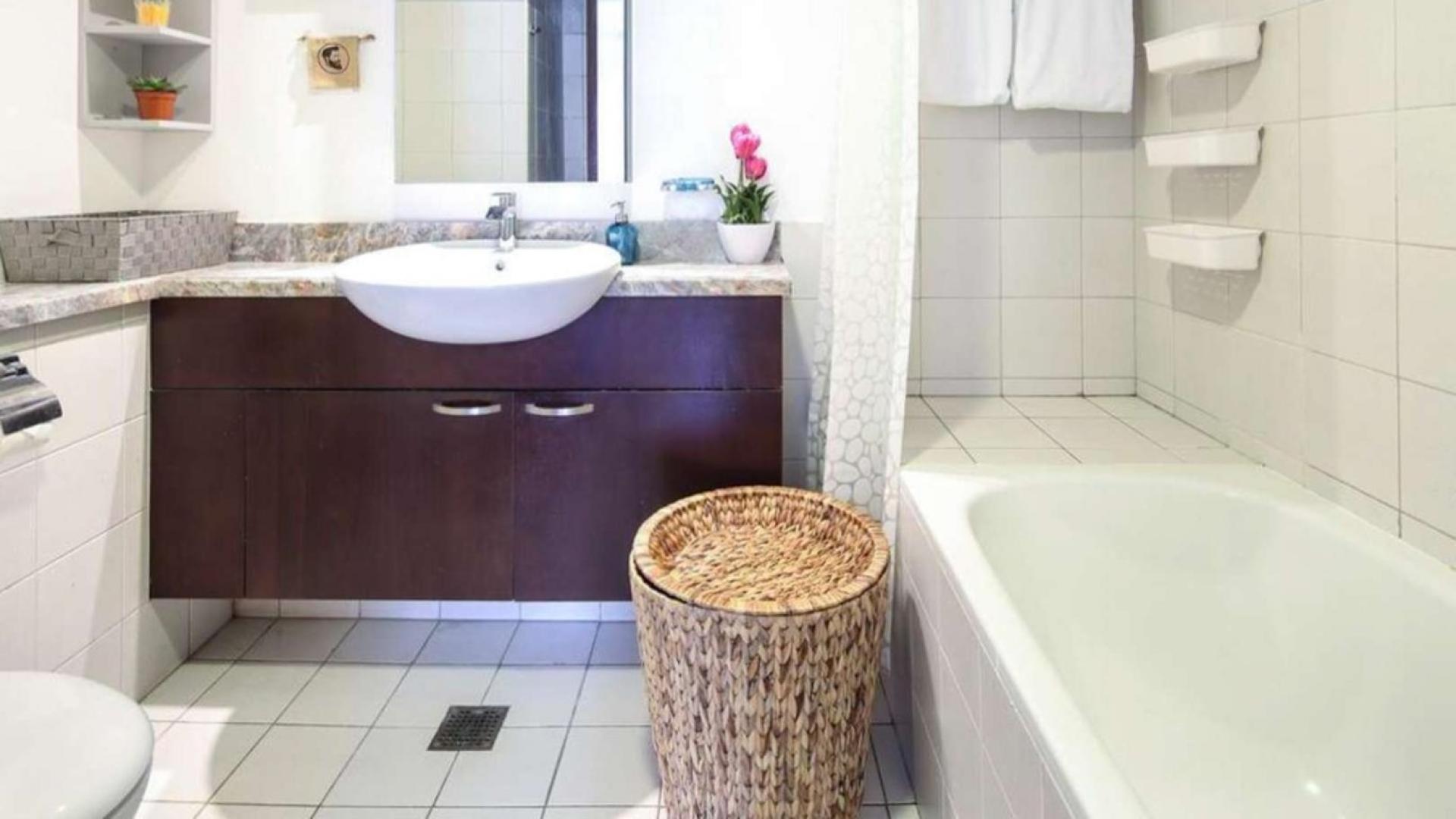 Stylish living room in Dubai Marina apartment for sale, featuring modern decor and cozy seating