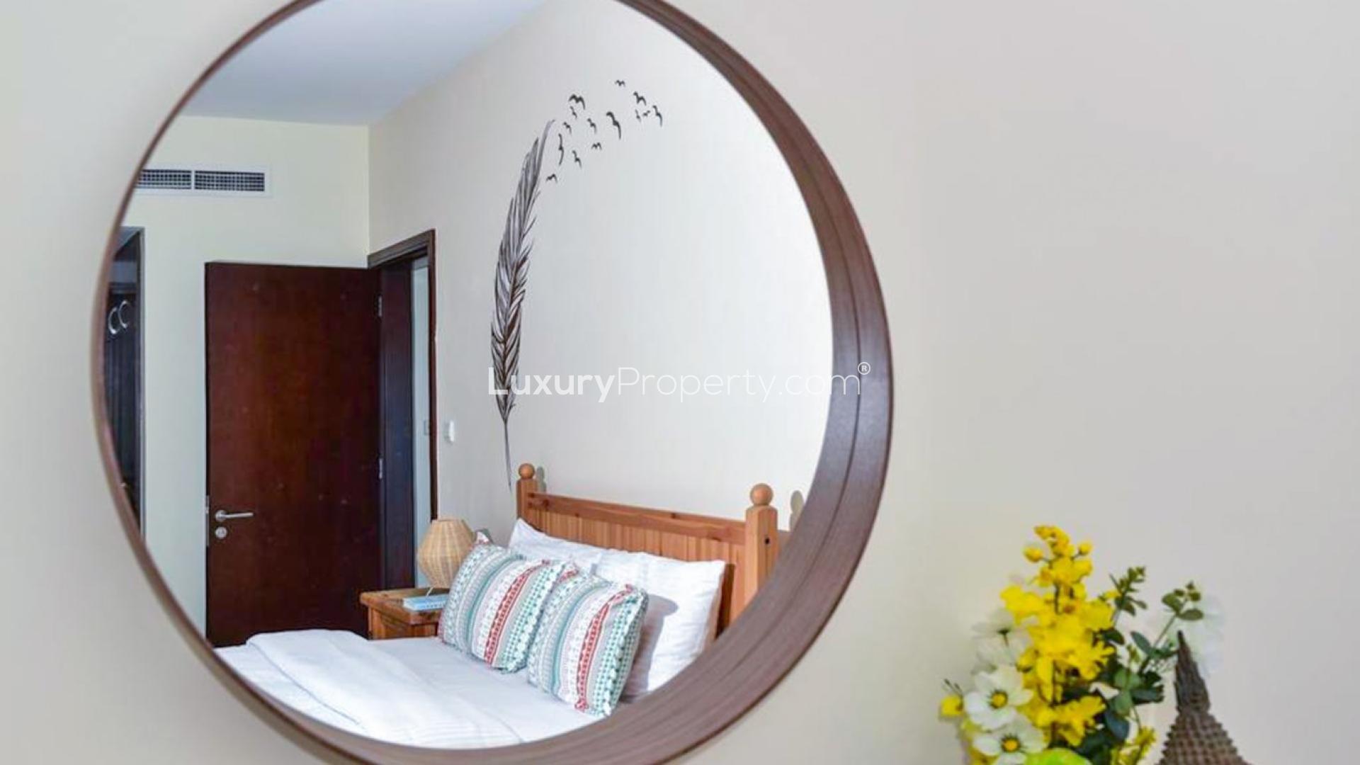 Modern living room in Dubai Marina apartment, featuring stylish decor and partial marina view