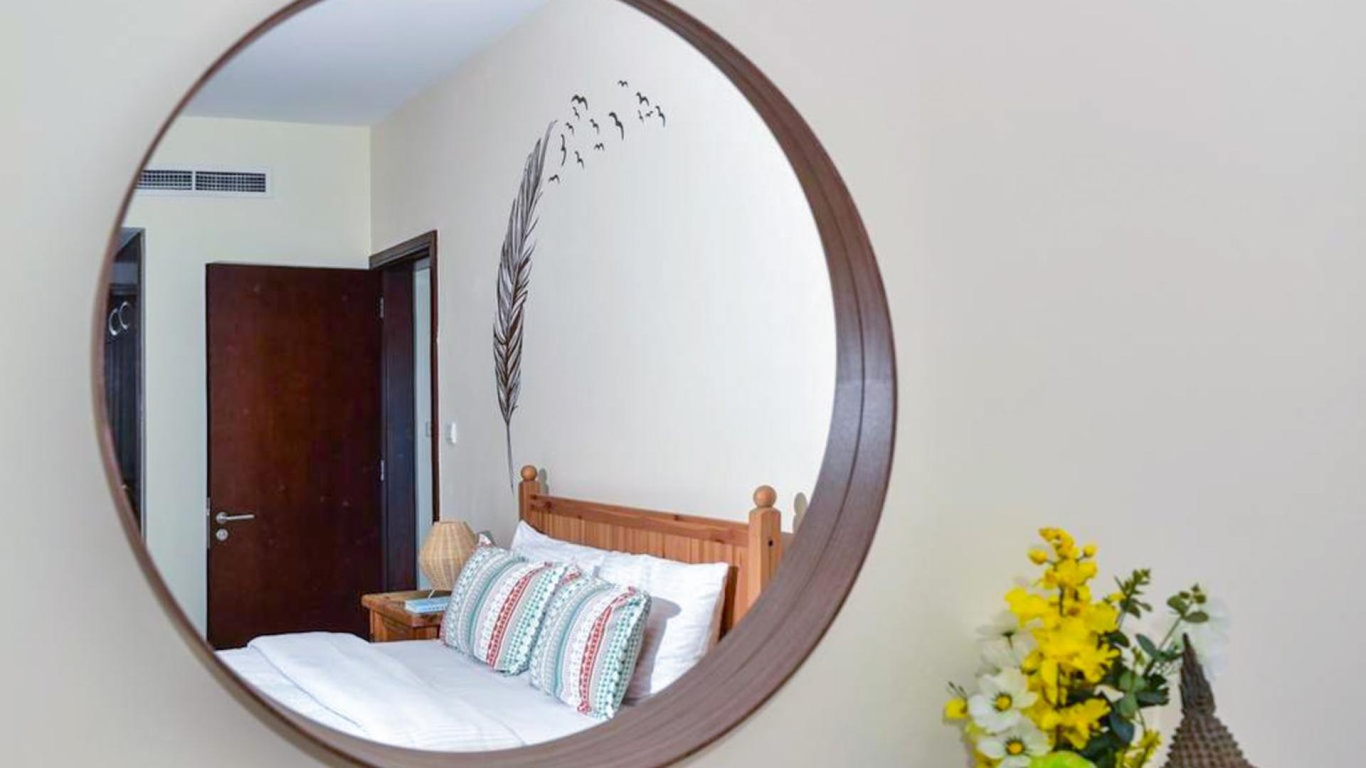 Modern living room in Dubai Marina apartment, featuring stylish decor and partial marina view