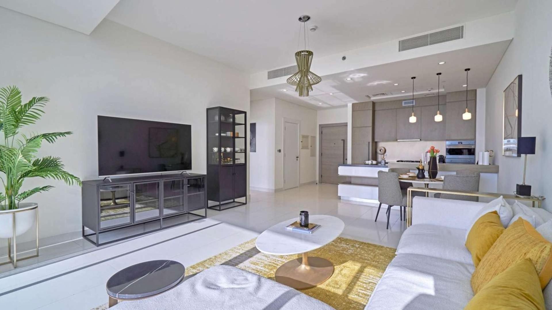 Modern living room in Serenia Residences apartment, Palm Jumeirah, with open kitchen and decor