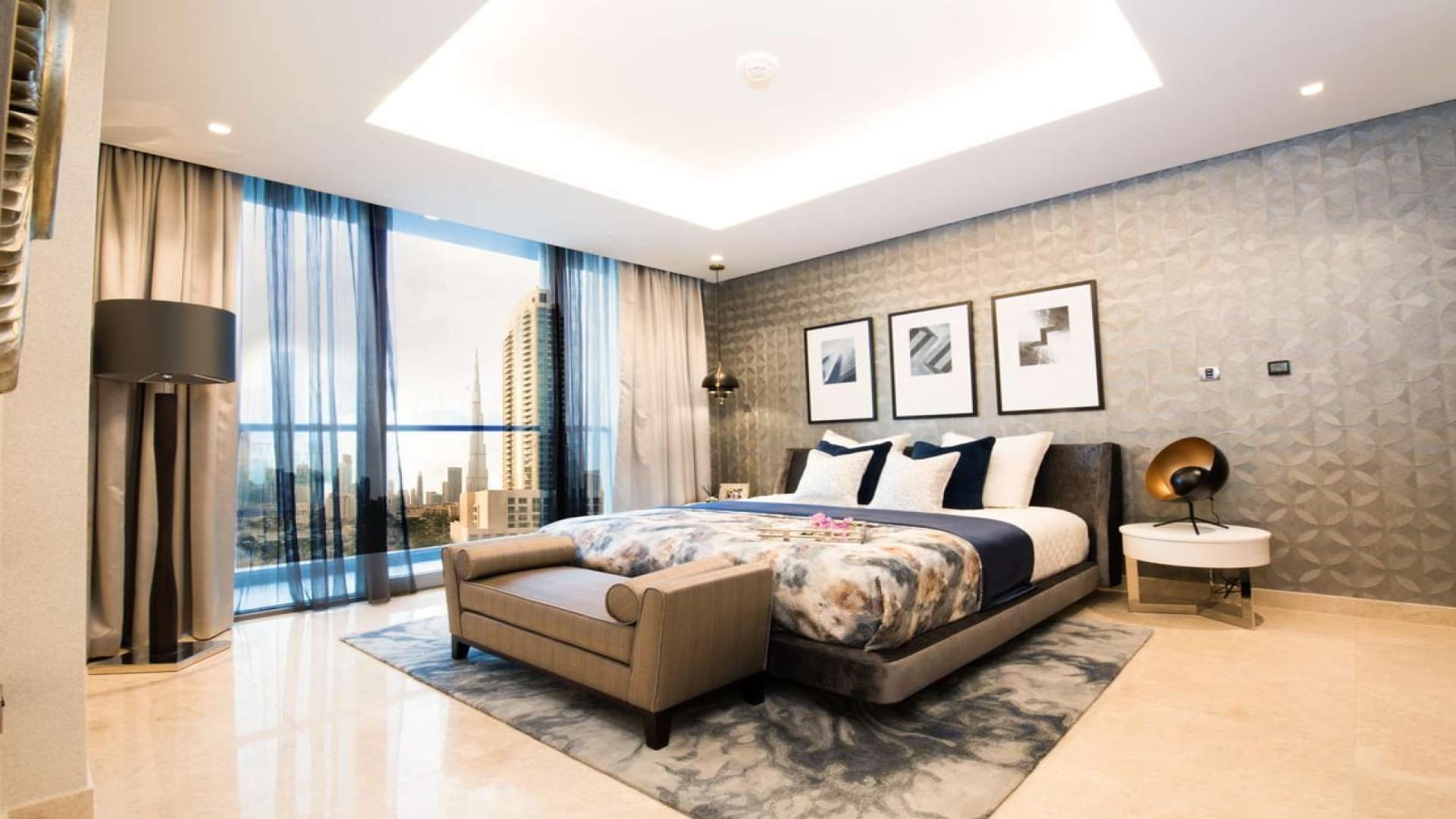 Luxurious open-plan kitchen and dining area in Business Bay apartment, Dubai Canal view