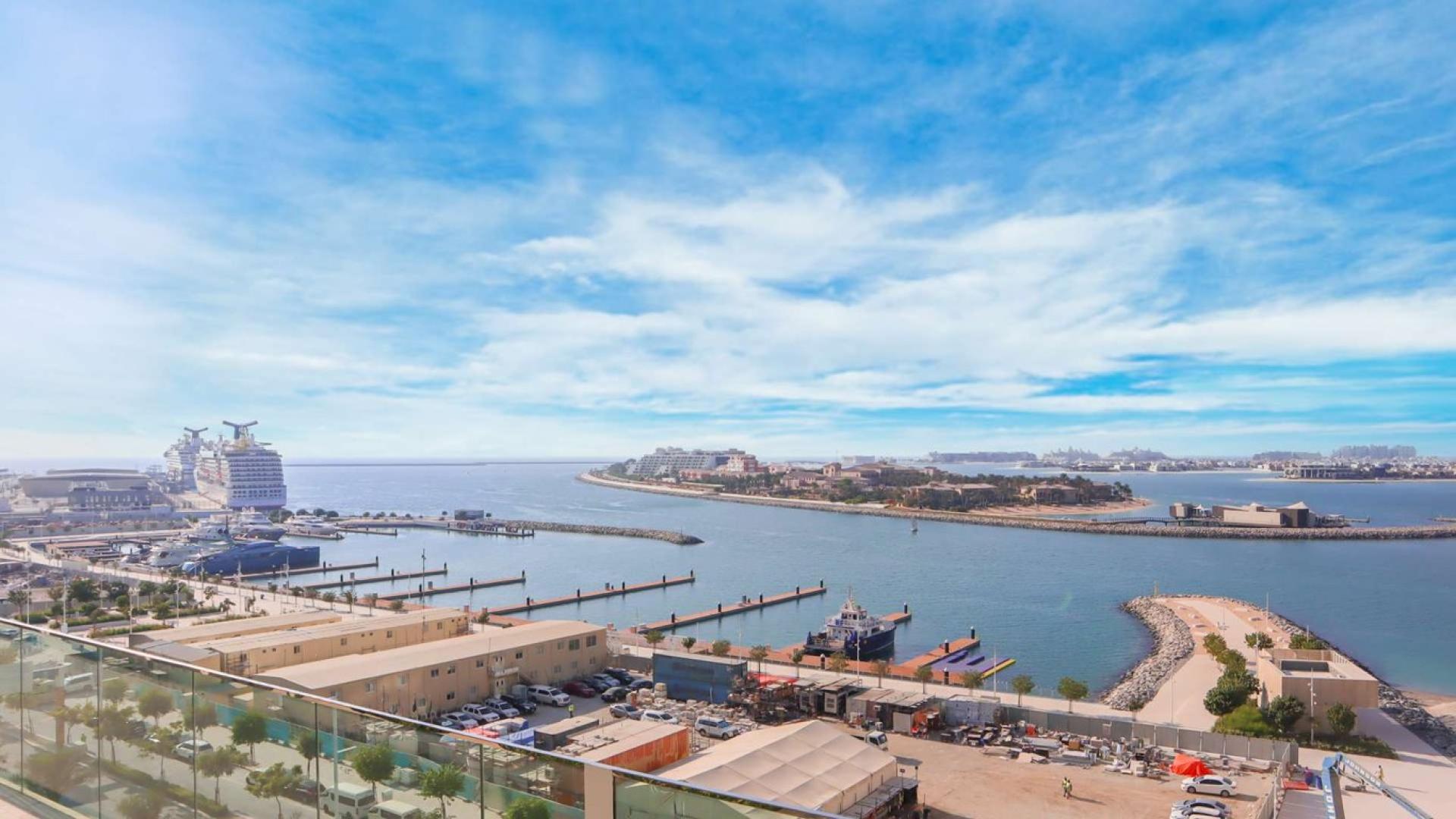 Emaar Beachfront apartment balcony with stunning view of Dubai Harbour and Palm Jumeirah