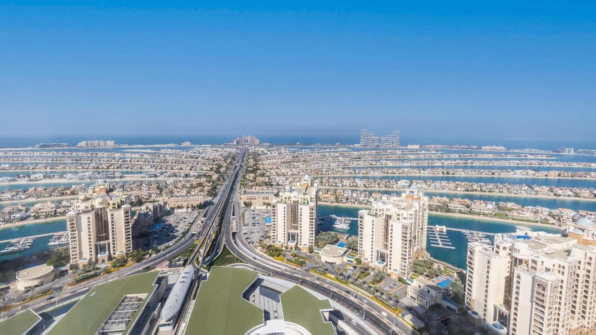 "Stunning panoramic view of Palm Jumeirah from luxury apartment at The Palm Tower.",Panoramic view of Palm Jumeirah from luxury apartment in The Palm Tower, Dubai