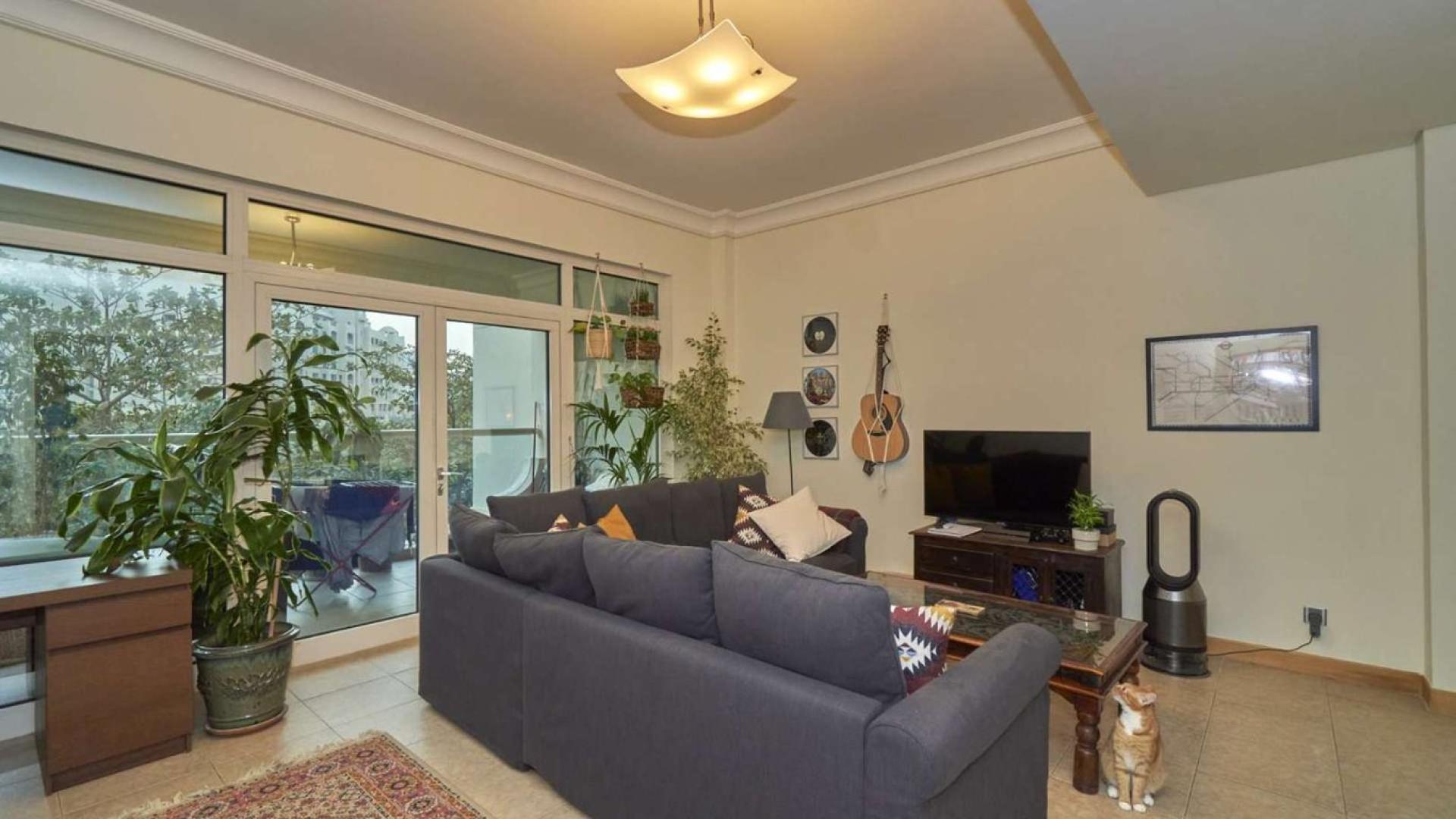 Living room in spacious Palm Jumeirah apartment, featuring cozy furnishings and modern decor
