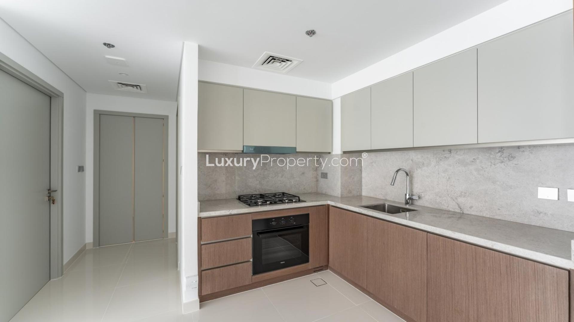 Balcony view of Dubai Harbour from Emaar Beachfront apartment, showcasing modern high-rise buildings