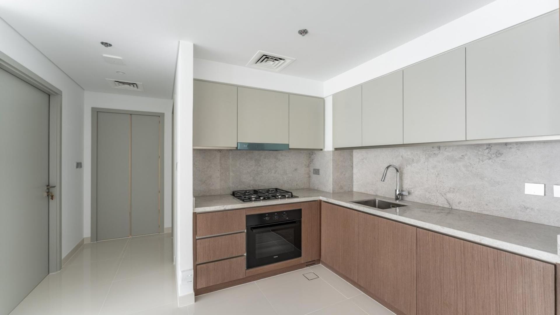 Balcony view of Dubai Harbour from Emaar Beachfront apartment, showcasing modern high-rise buildings