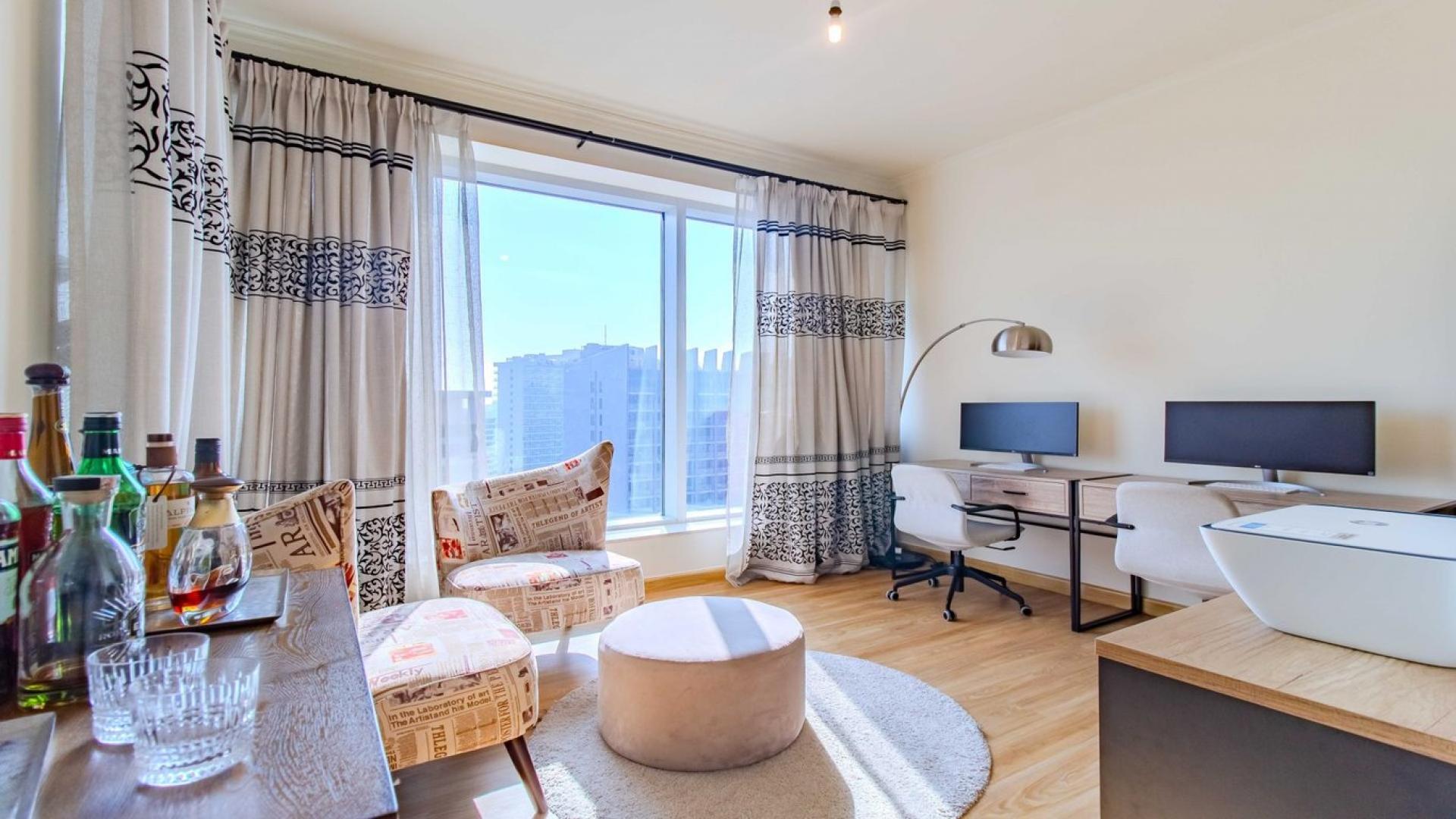 Stylish living room in Downtown Dubai apartment with modern decor and skyline views