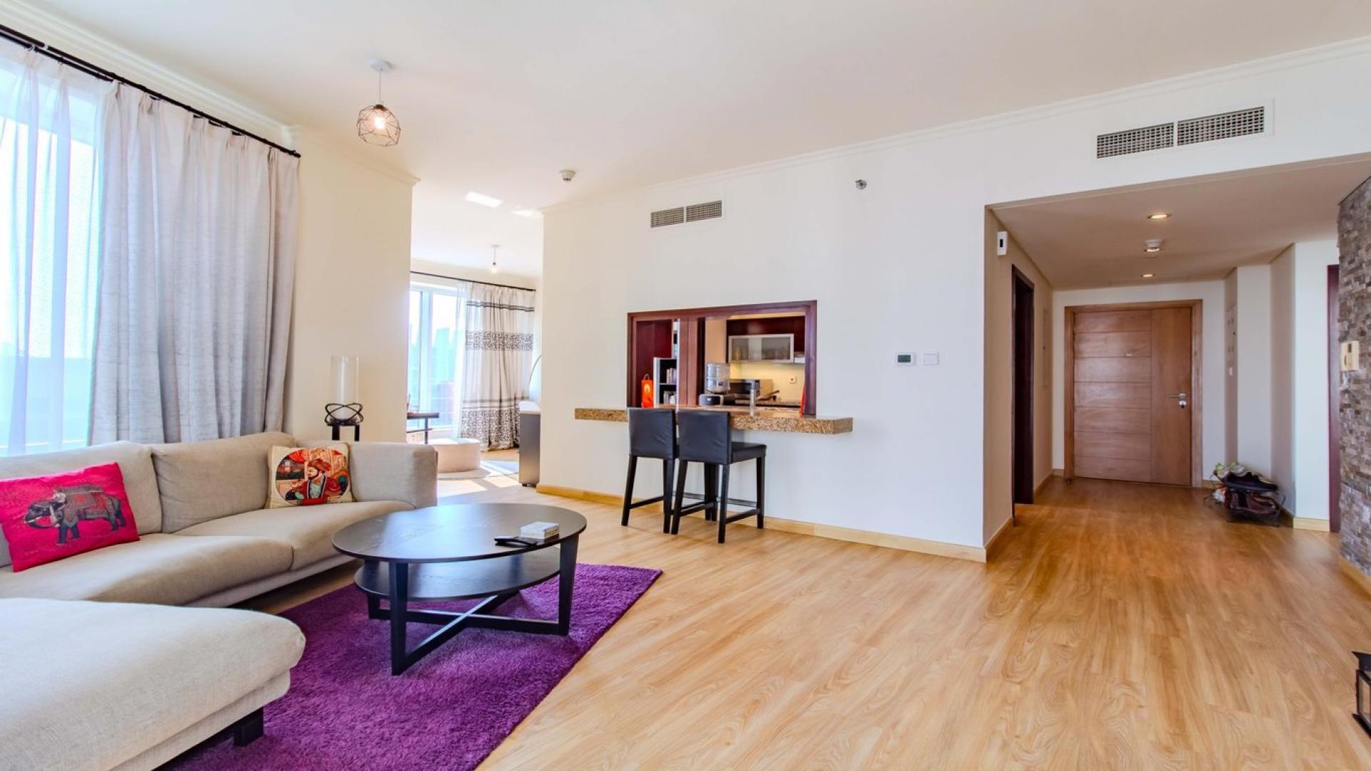 Stylish living room in Burj Views apartment, Downtown Dubai, with skyline balcony access