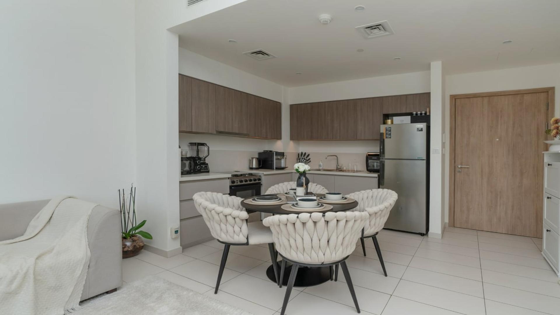 Modern living room in Executive Residences 1 apartment, Dubai Hills Estate, with balcony view