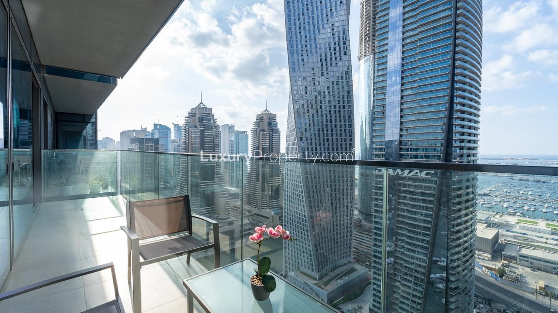 Modern living room in Marina Gate apartment with balcony and stunning Dubai Marina views