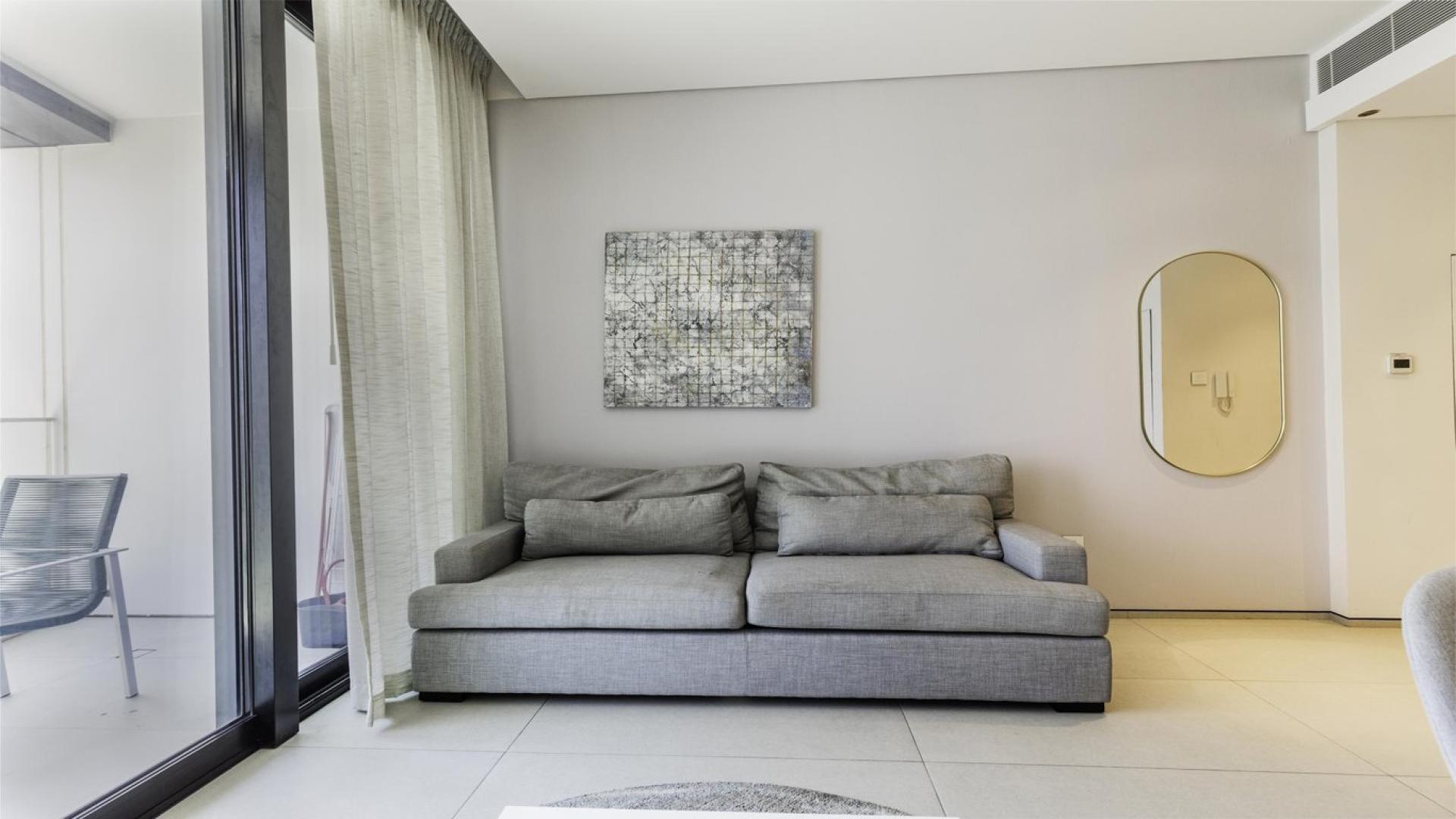 Furnished living area in Jumeirah Gate Tower 1 apartment, featuring modern decor and amenities