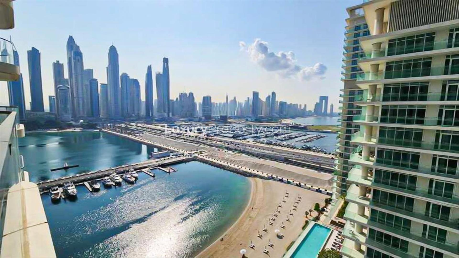 Modern living room in Emaar Beachfront apartment, Dubai Harbour, with marina views through large windows