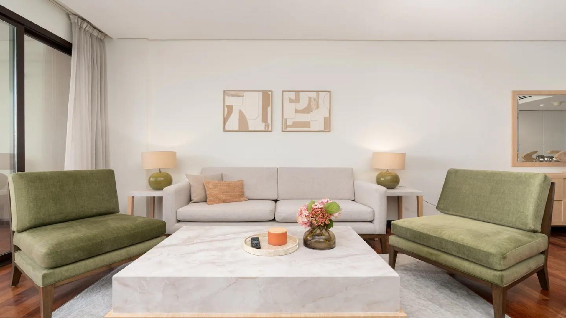 Furnished living room in Palm Jumeirah apartment, featuring modern decor and elegant seating