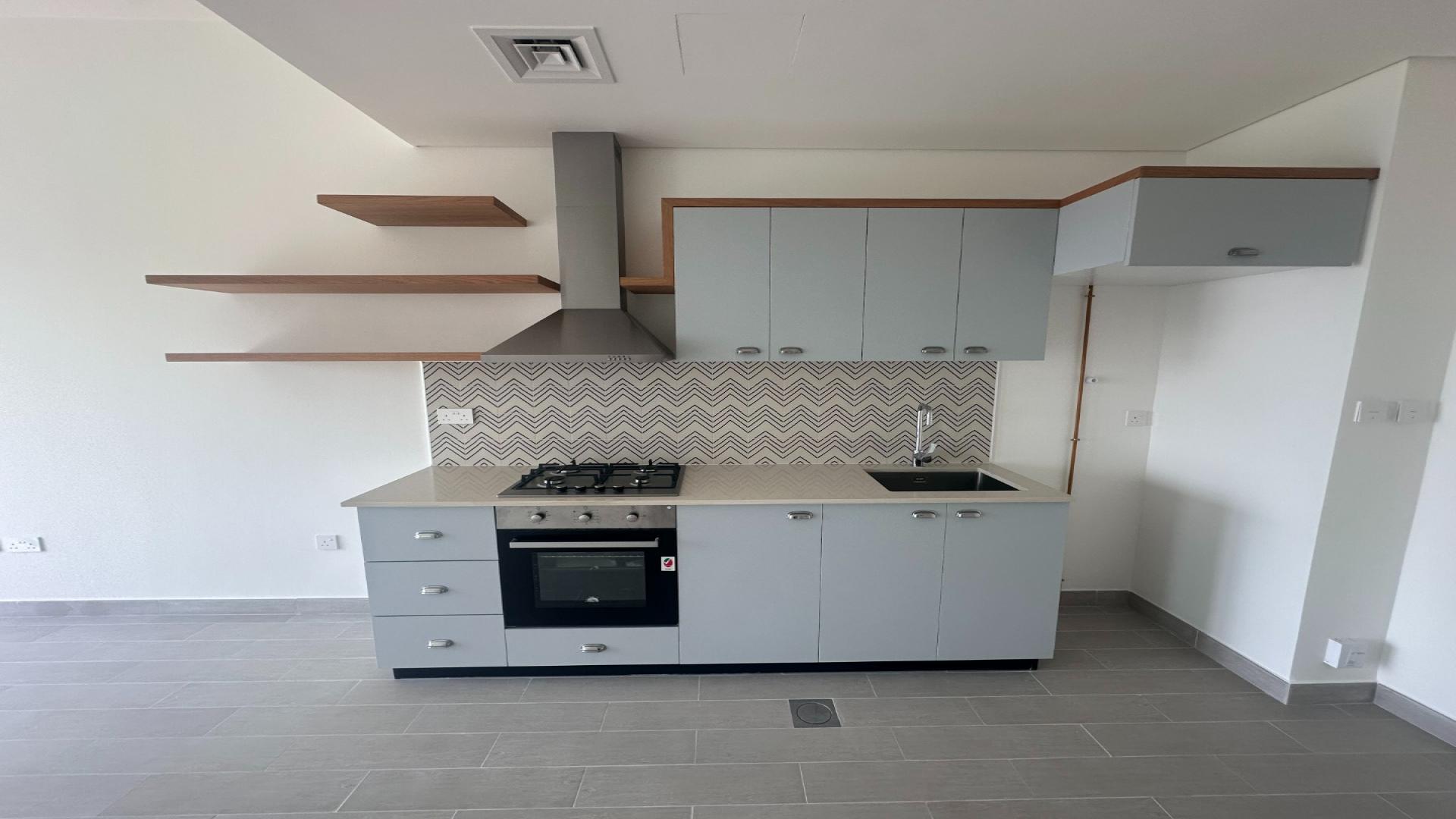 Vacant modern apartment with sliding doors in Golfville, Dubai Hills Estate, available for sale