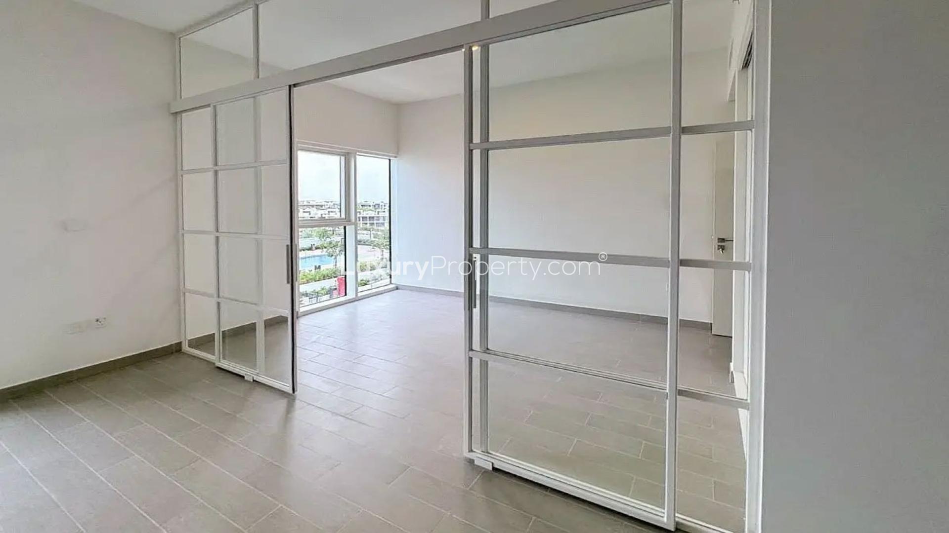 Modern one-bedroom apartment interior with large windows in Dubai Hills Estate, Golfville