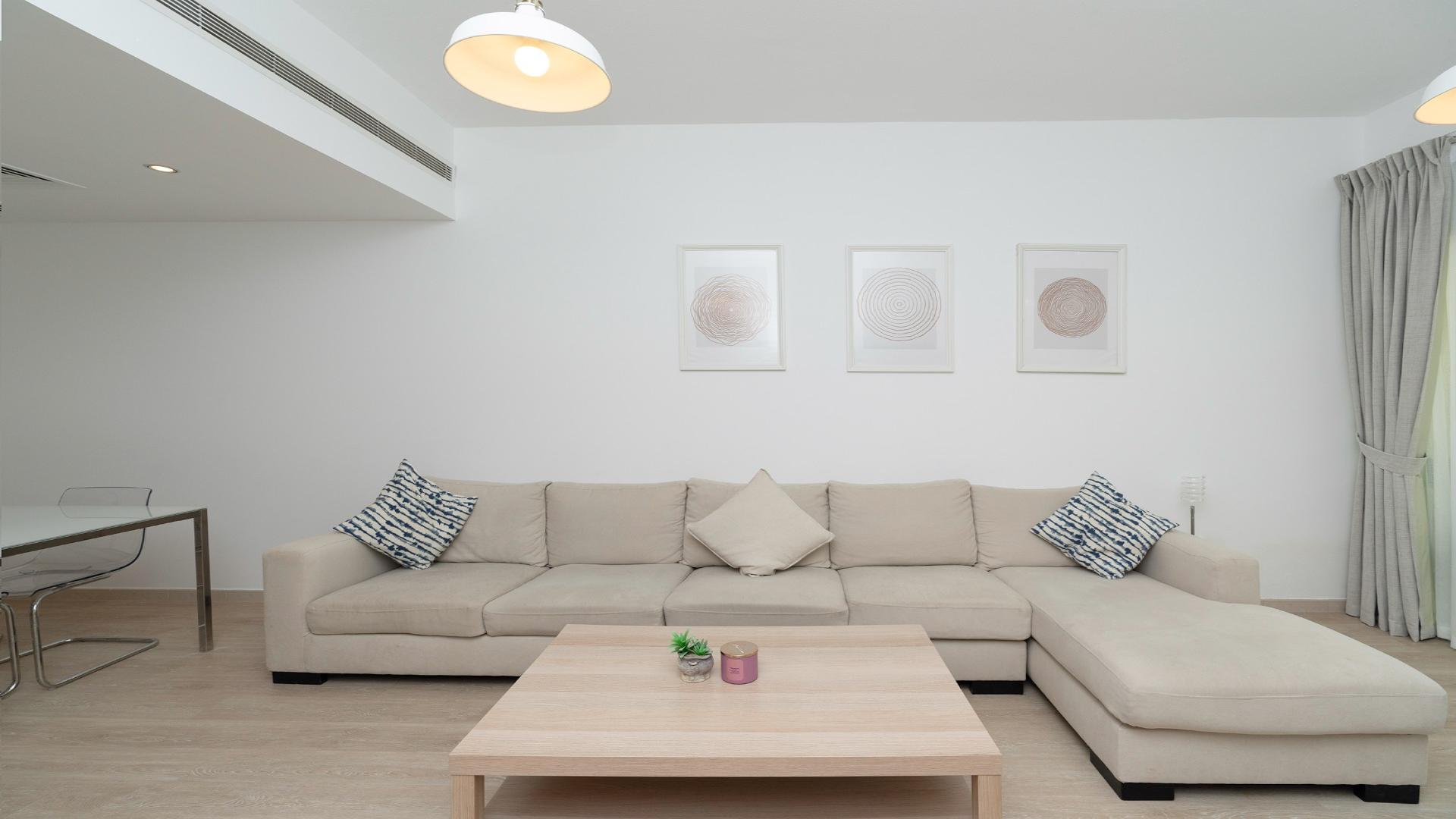 "Cozy Al Thayyal apartment patio with modern seating in The Greens community.",Modern living room in fully upgraded Al Thayyal apartment, The Greens, with stylish decor