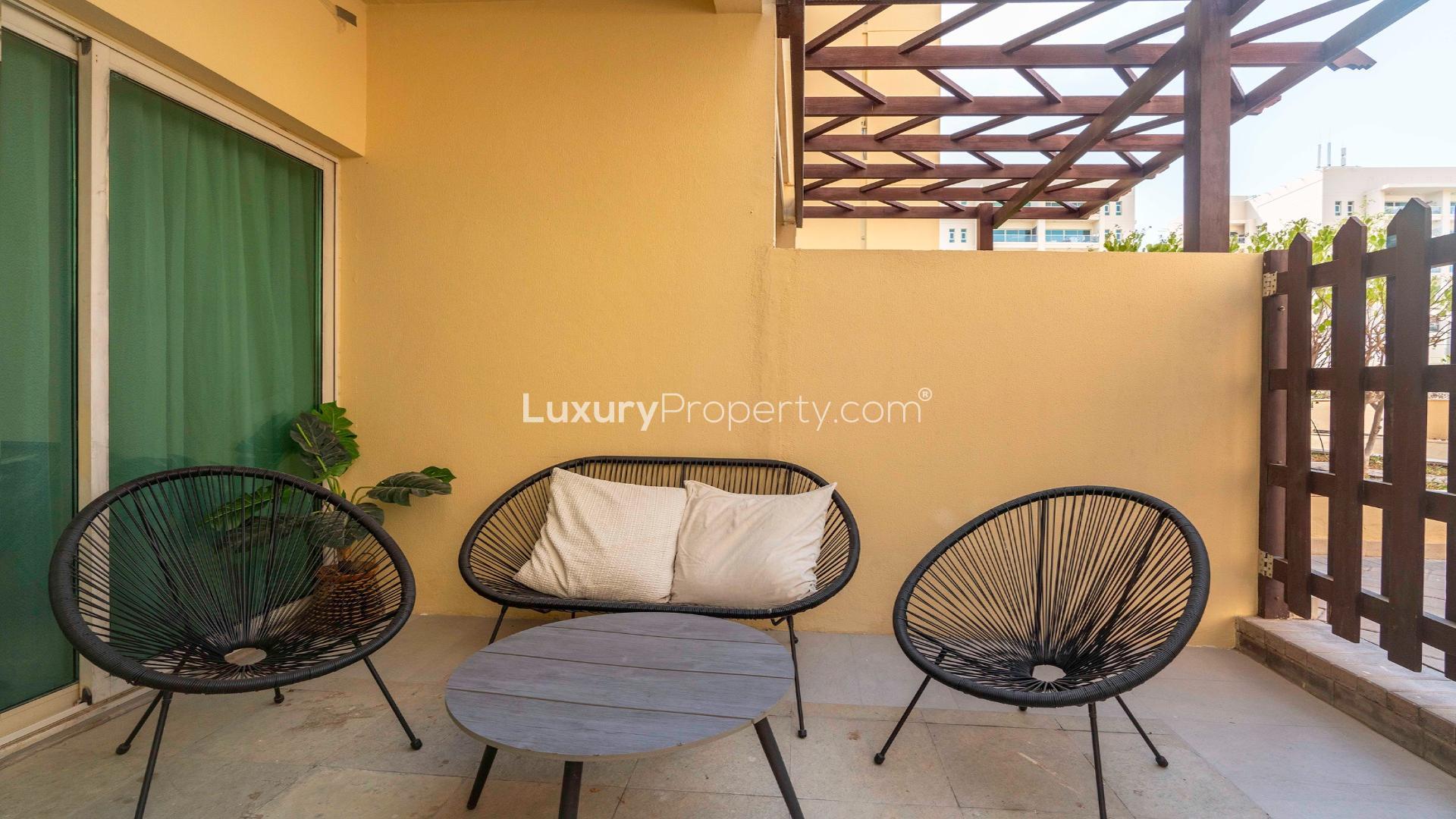 Modern living room in Al Thayyal apartment, The Greens, with stylish decor and natural light