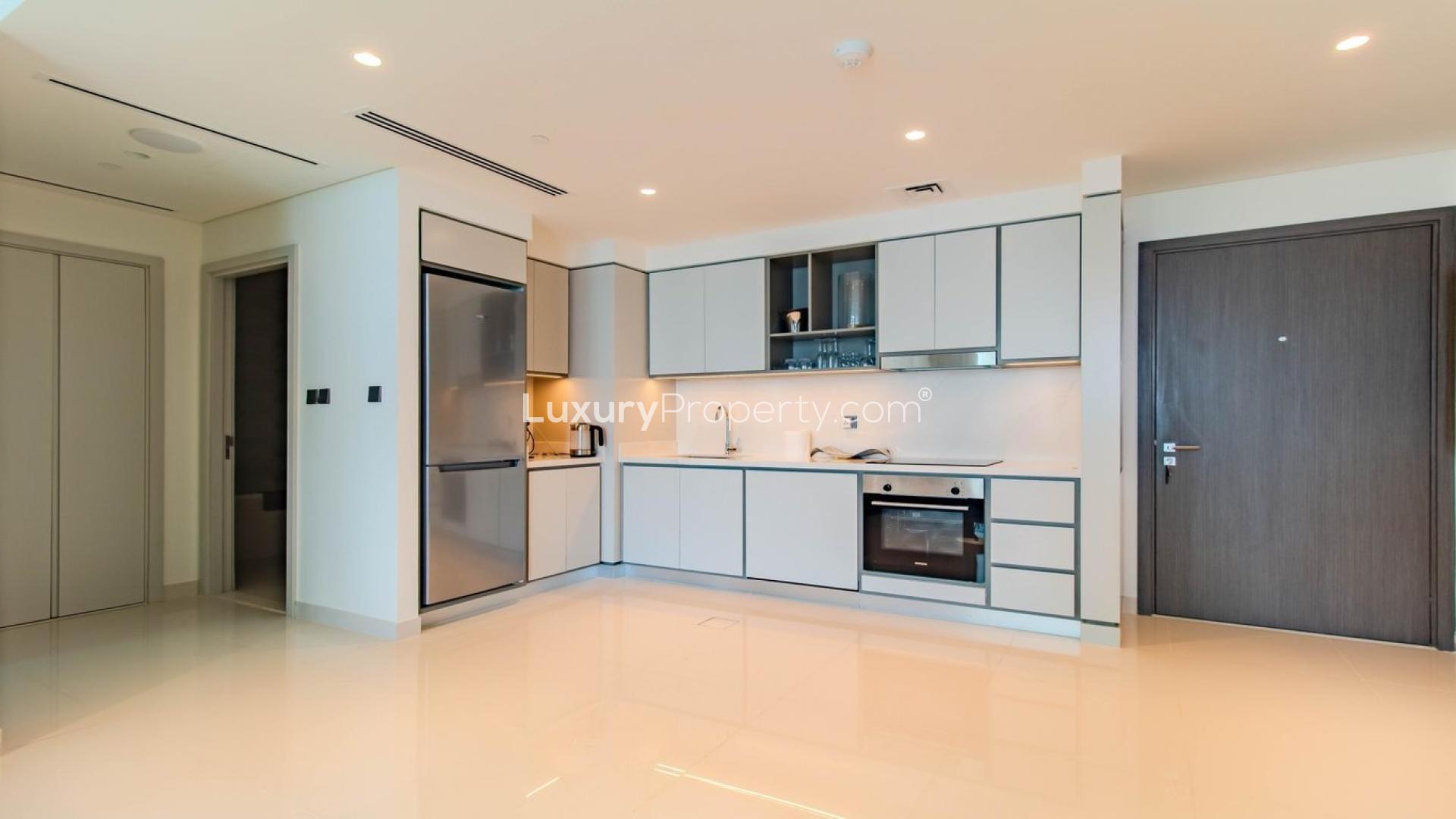 Elegant living room in Emaar Beachfront apartment, Dubai Harbour, with modern decor and sea view