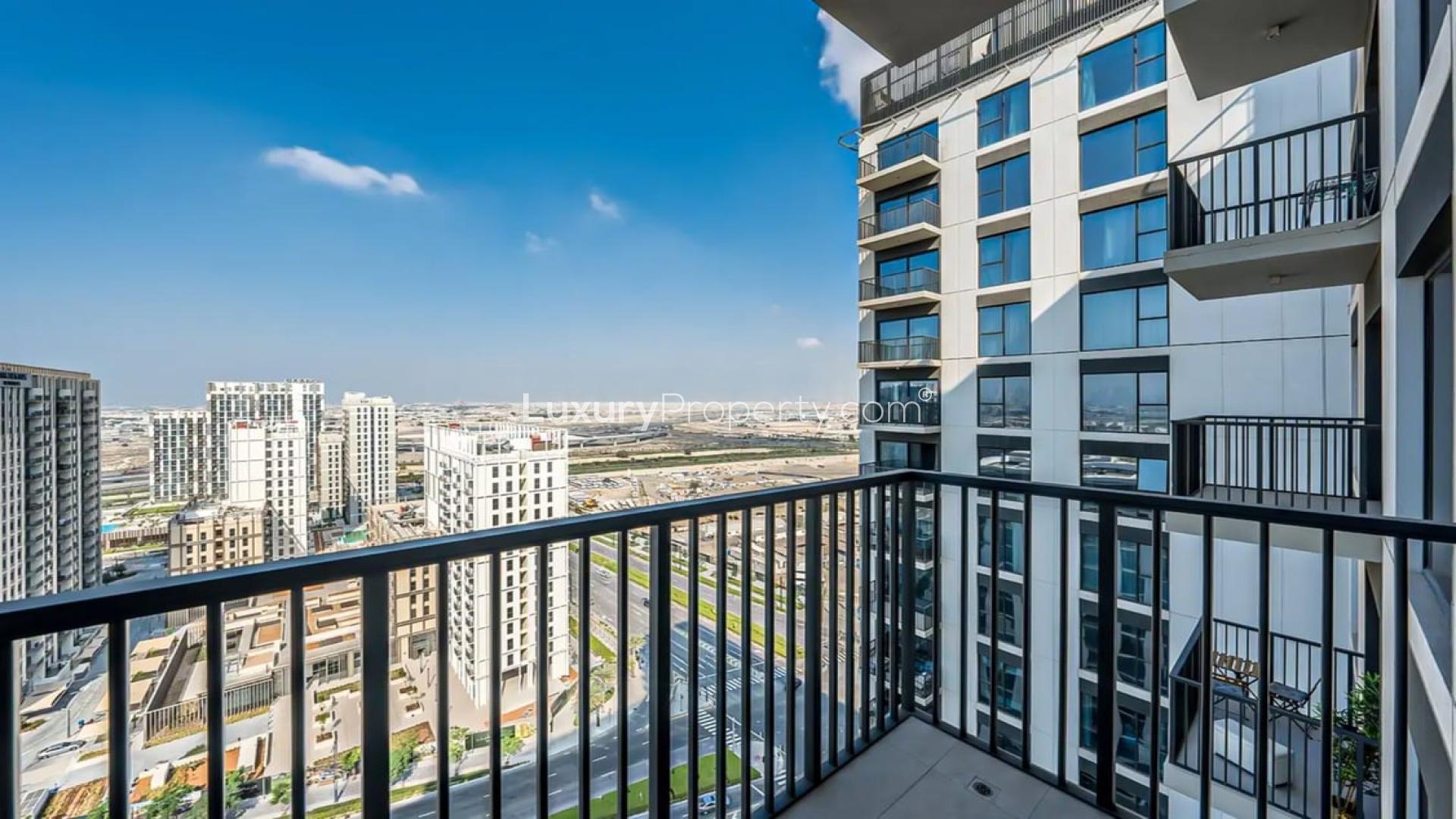 High-floor Dubai Hills Estate apartment interior with modern kitchen and balcony view