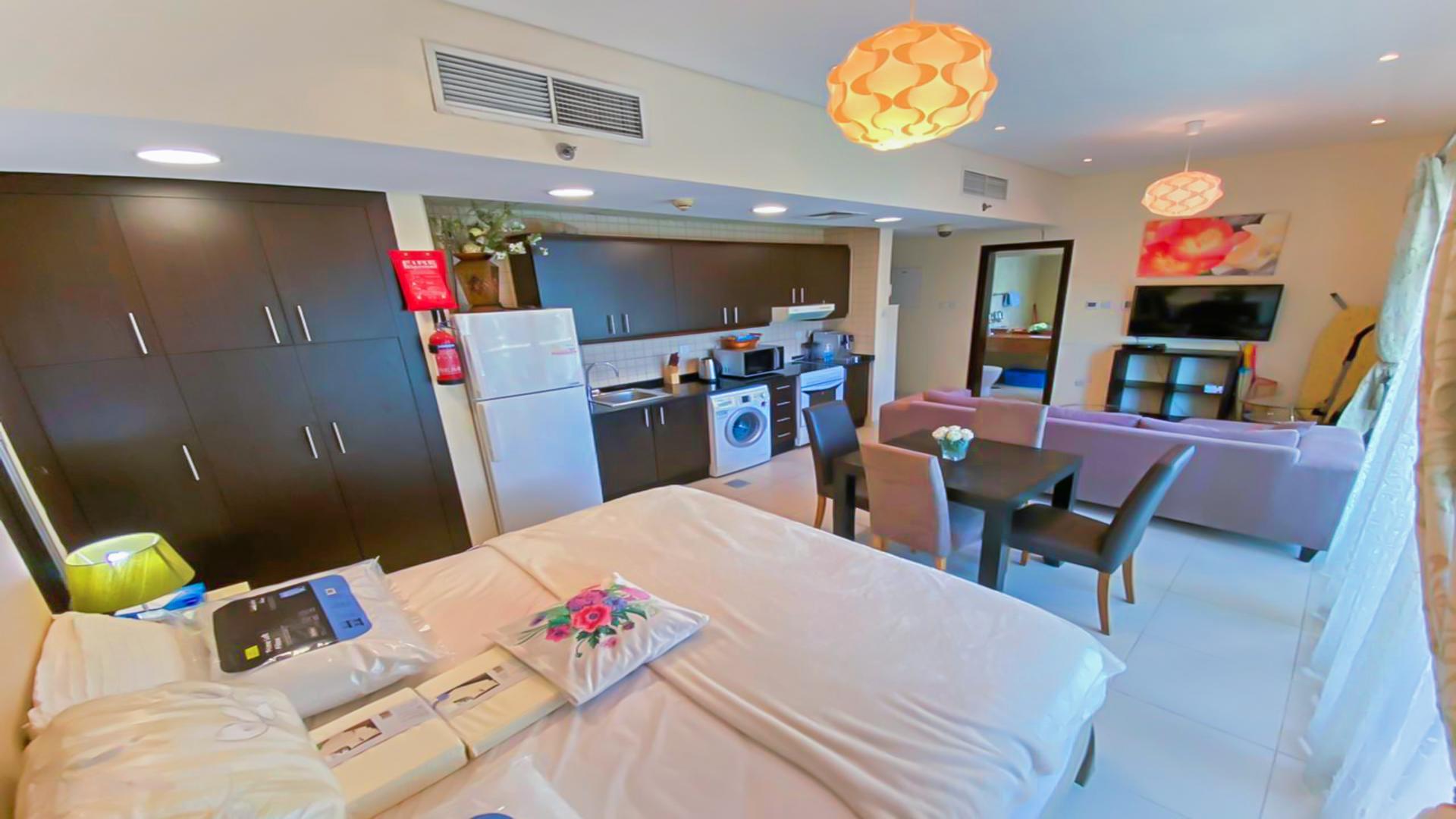 Modern 1-bedroom apartment interior in Royal Oceanic, Dubai Marina with balcony view