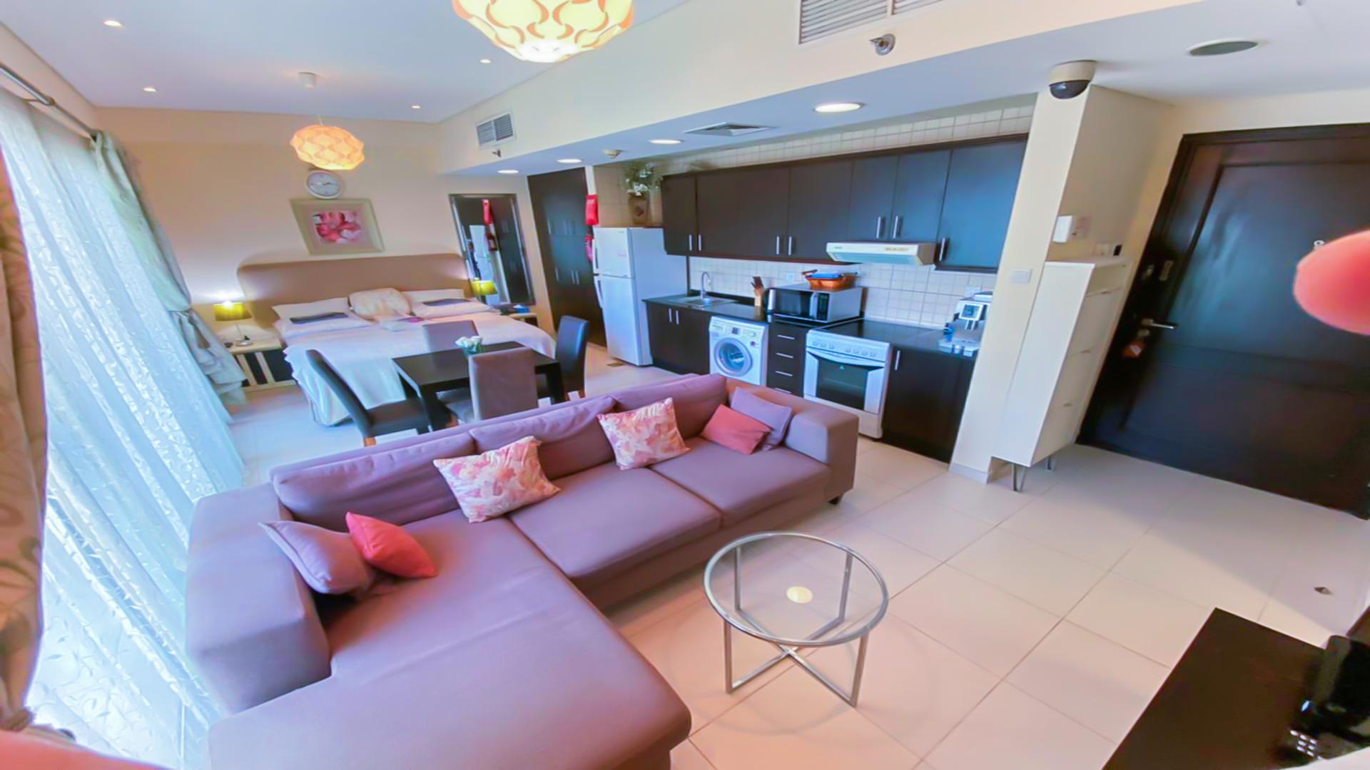 Modern 1-bedroom apartment interior in Royal Oceanic, Dubai Marina with cozy living area