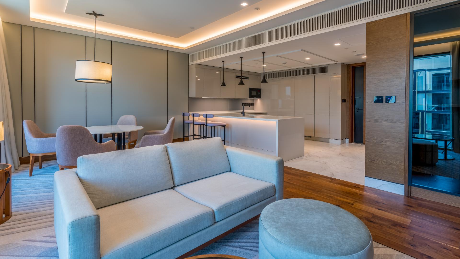 Exterior view of Caesars Bluewaters Dubai apartment with sea view and palm-lined pathways