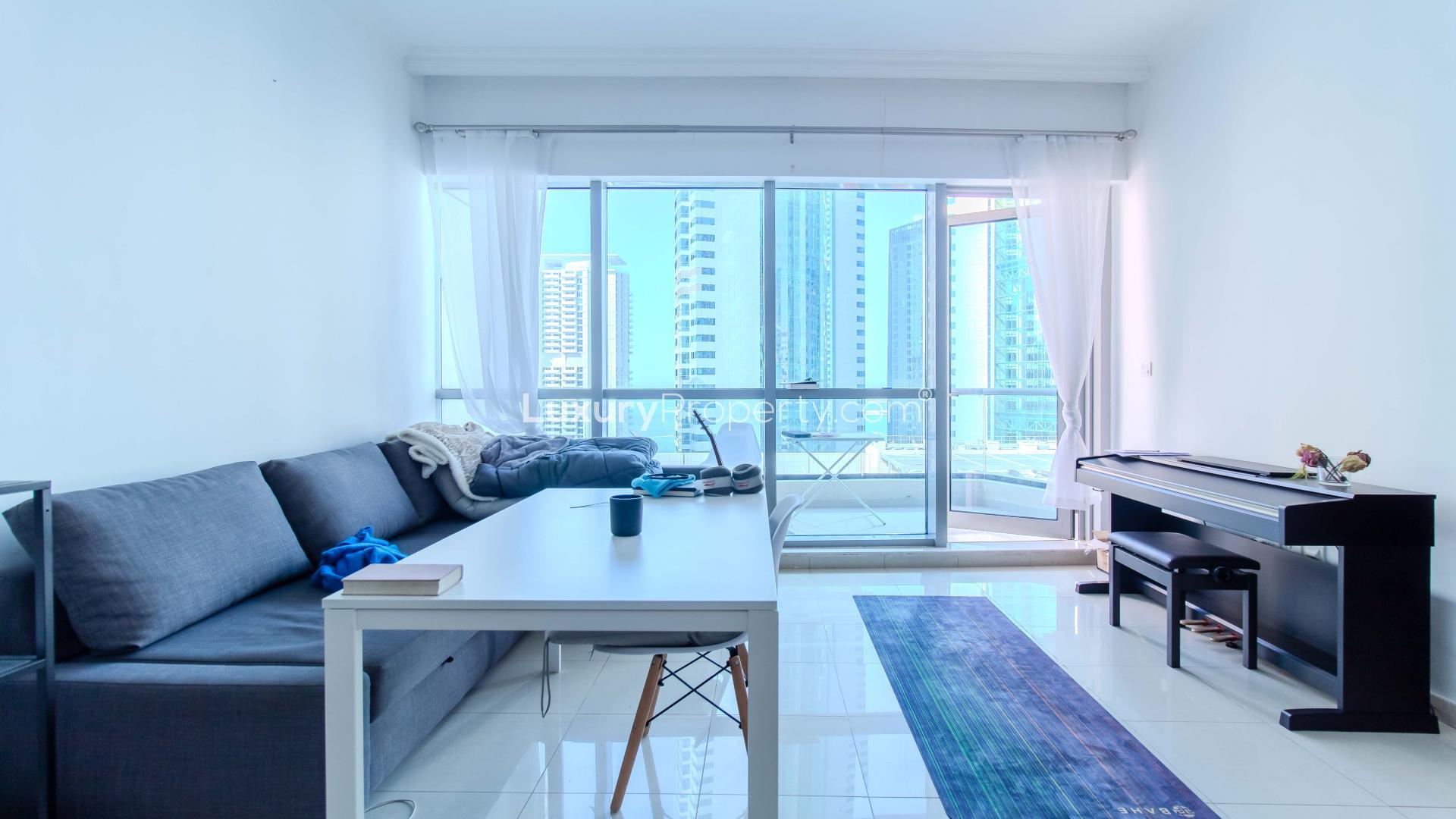 Modern bedroom in Bay Central West apartment, Dubai Marina, with city view through large window