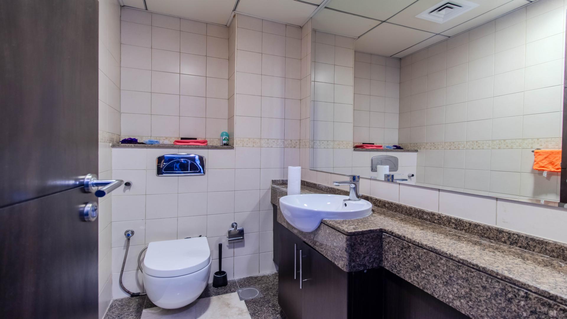 Bright living room in Bay Central West apartment, Dubai Marina, with modern furniture and balcony