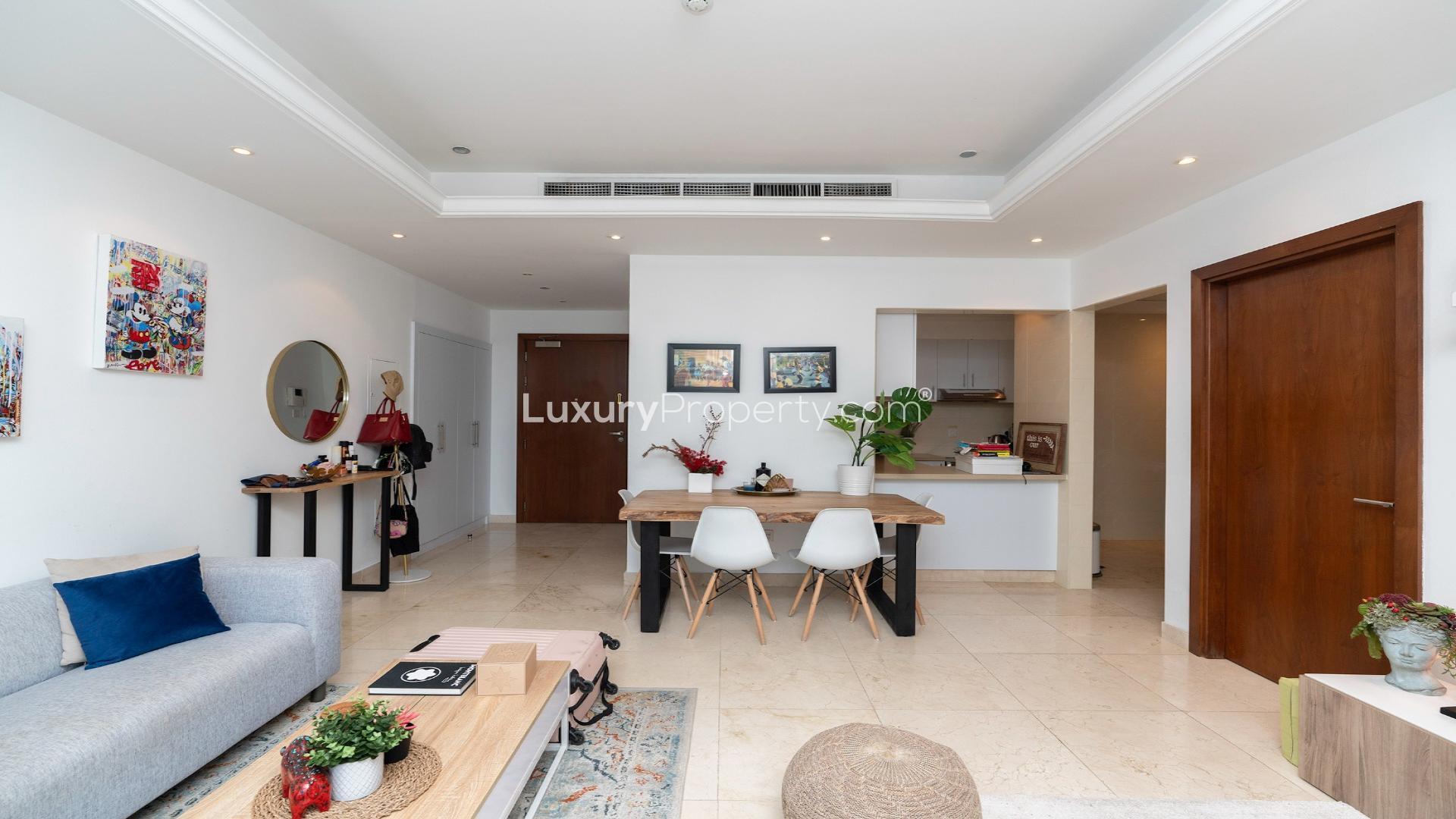 Furnished living room in Orra Marina apartment with modern decor and natural light