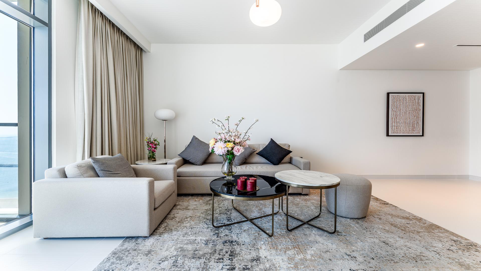 N/A,Stylish living room in Emaar Beachfront apartment, Dubai Harbour, featuring modern decor and furnishings