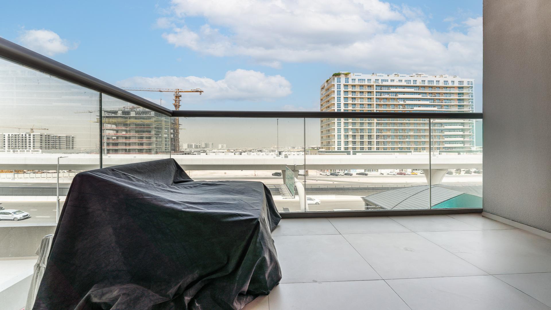 View from 1-bed apartment balcony in East 40, Al Furjan, overlooking highway and cityscape