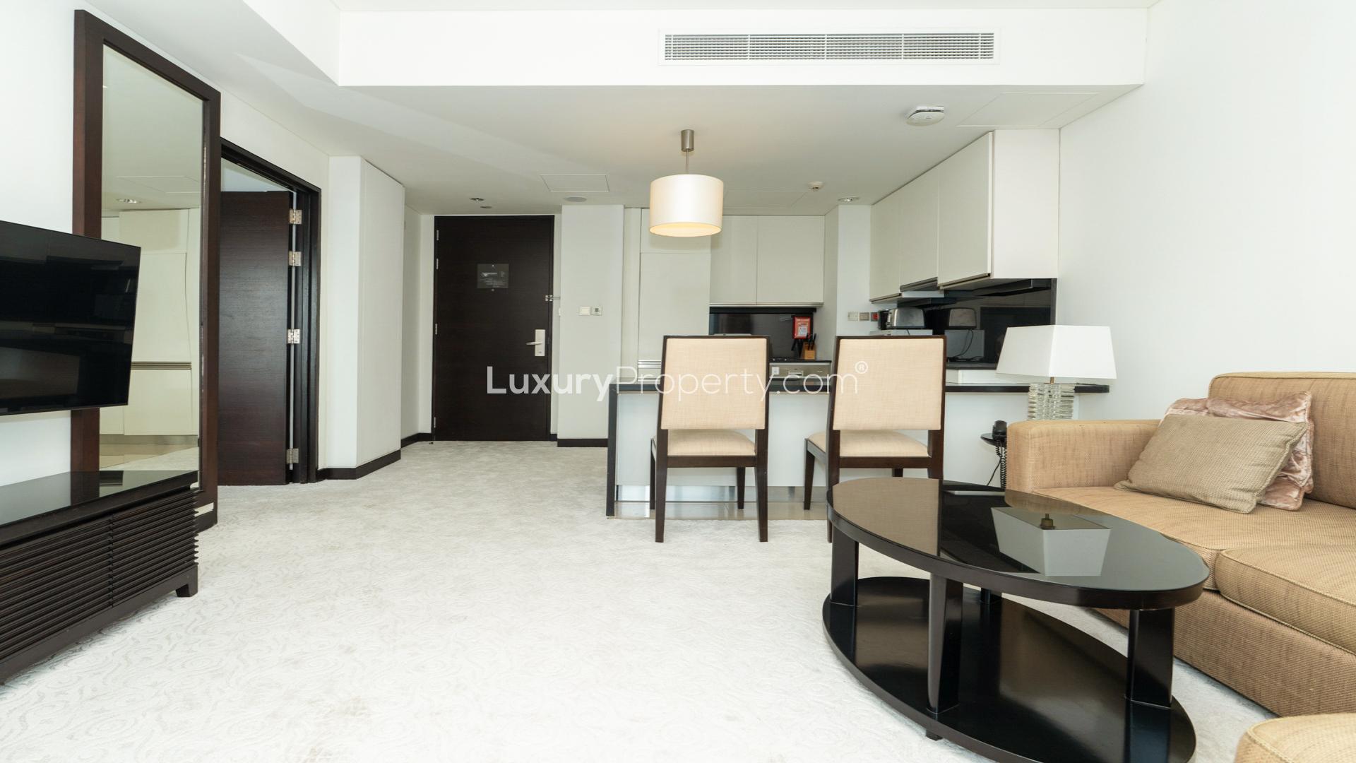 Modern living room in Dubai Marina apartment with city view, cozy seating, and natural light