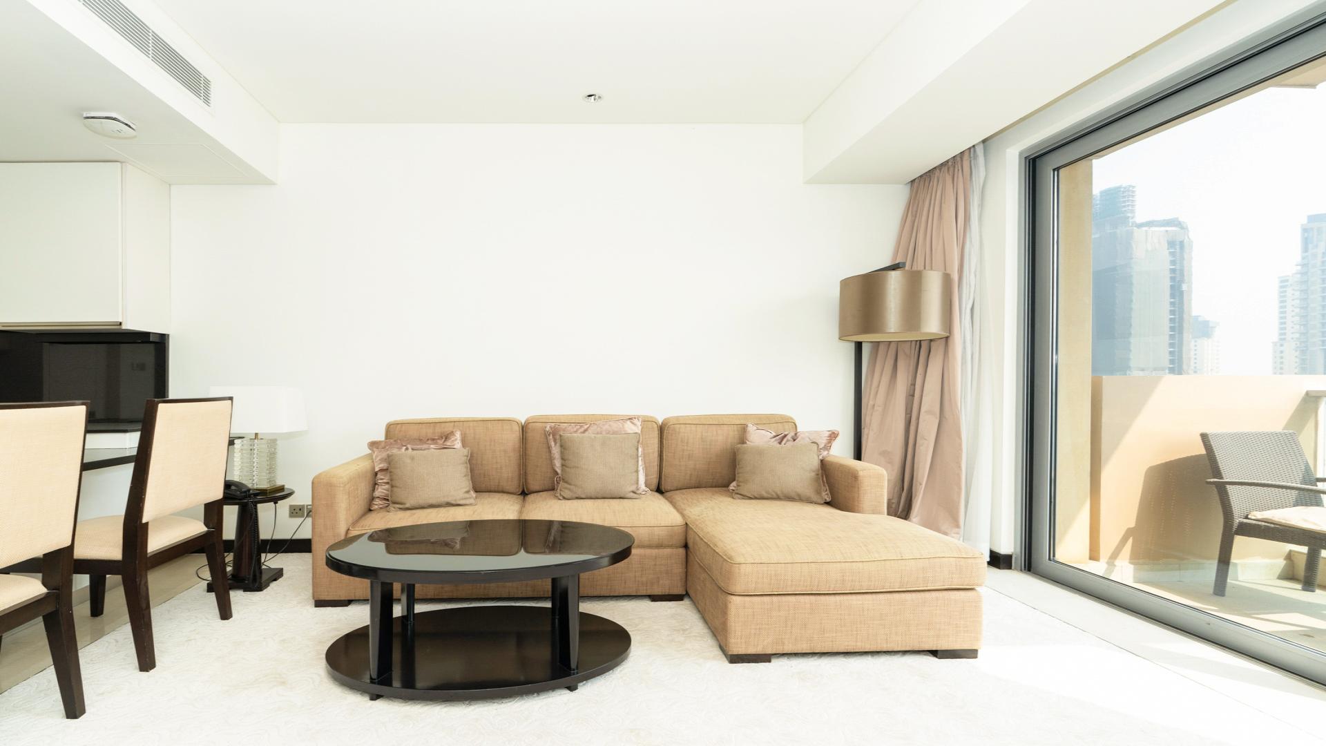 Modern living room in Dubai Marina apartment with balcony and city view, JW Marriott Hotel