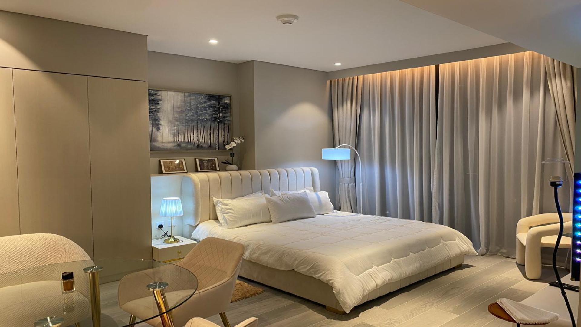 Dubai Marina Walk apartment view with illuminated skyline and waterfront at night