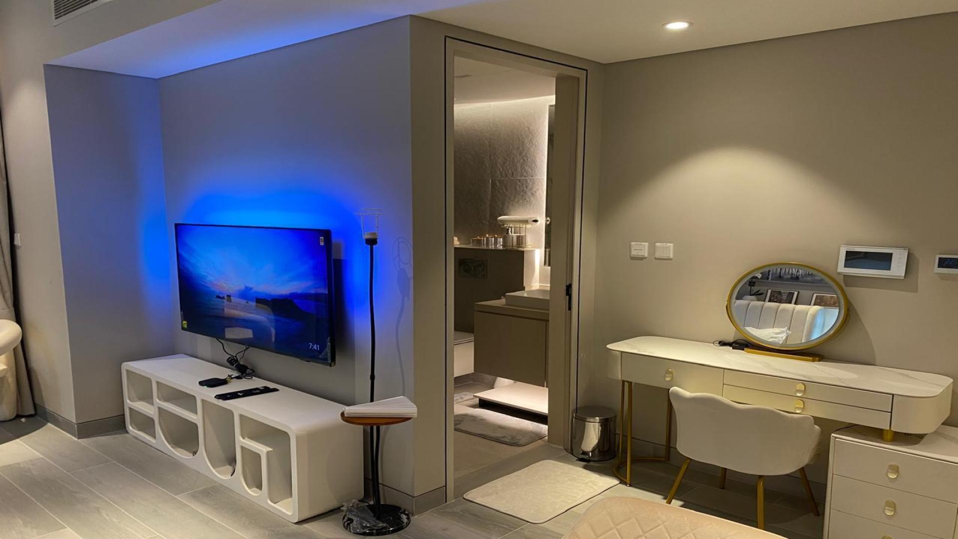 Modern bedroom in Dubai Marina Walk apartment with cozy decor and ambient lighting