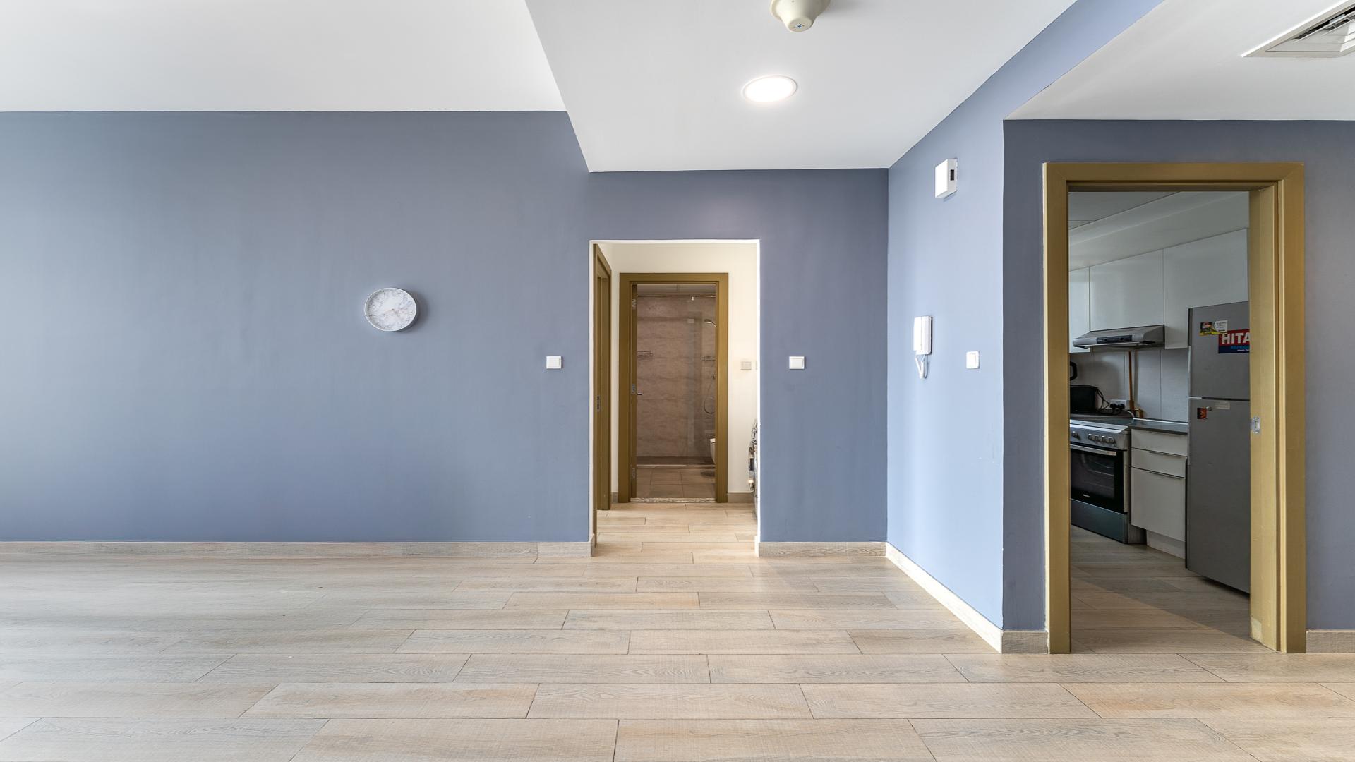 Modern kitchen and hallway in Bloom Towers C apartment, Jumeirah Village Circle